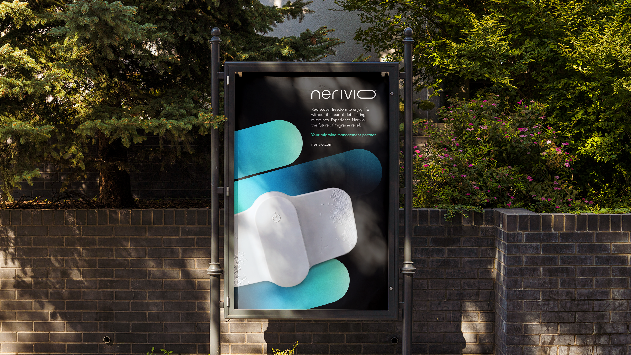 Outdoor billboard advertising Nerivio migraine treatment device, surrounded by trees and bushes.