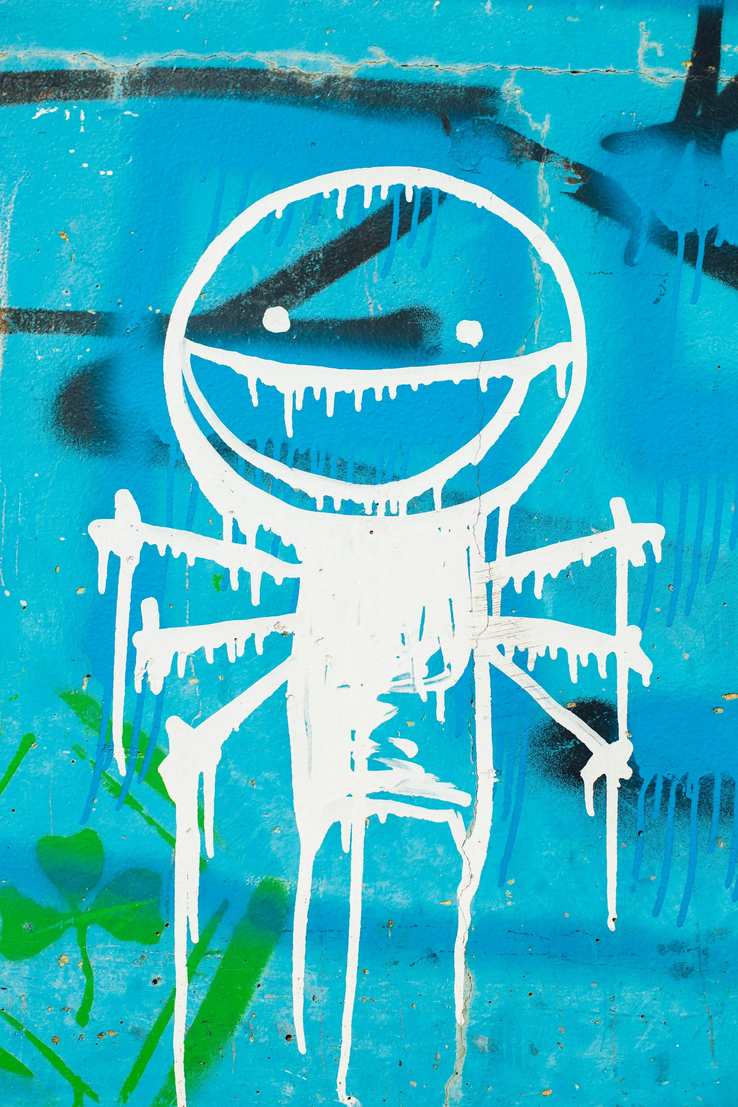 Street art graffiti of a smiling figure , symbolising hope, confidence and self-exression.