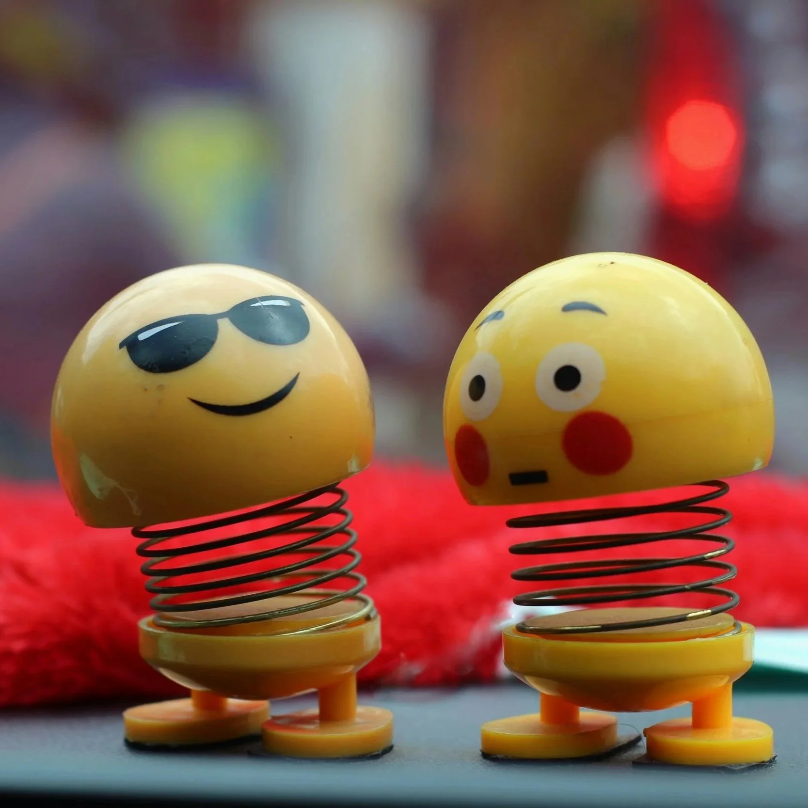 Close-up of two playful yellow faced toys, representing creativity, imagination and emotional expression
