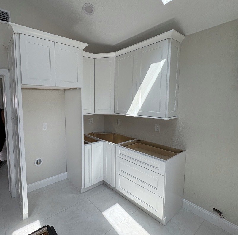 Kitchen cabinets installed but no countertop yet.