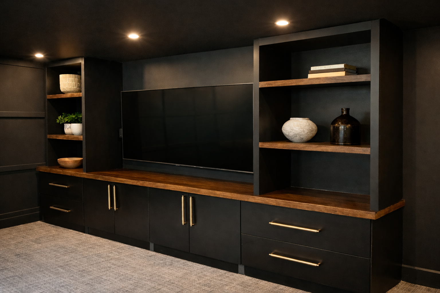 Black wall unit with wooden shelves, a flat-screen TV, and decorative items on the shelves, in a modern living room.