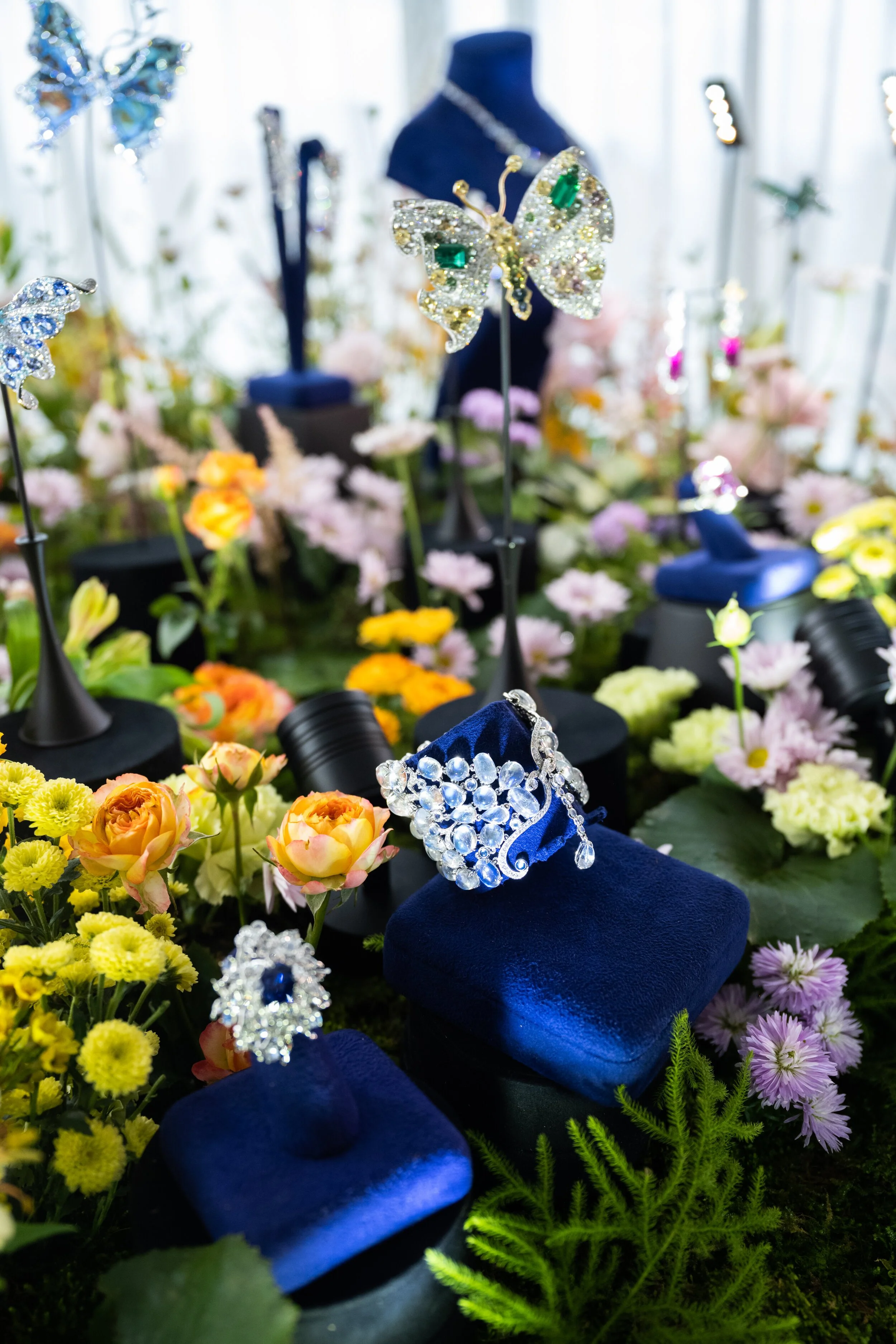 Jewelry display with butterfly-themed accessories and assorted flowers.