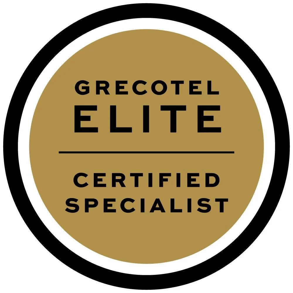 Gold and black circular badge with the words "Grecotel Elite Certified Specialist"