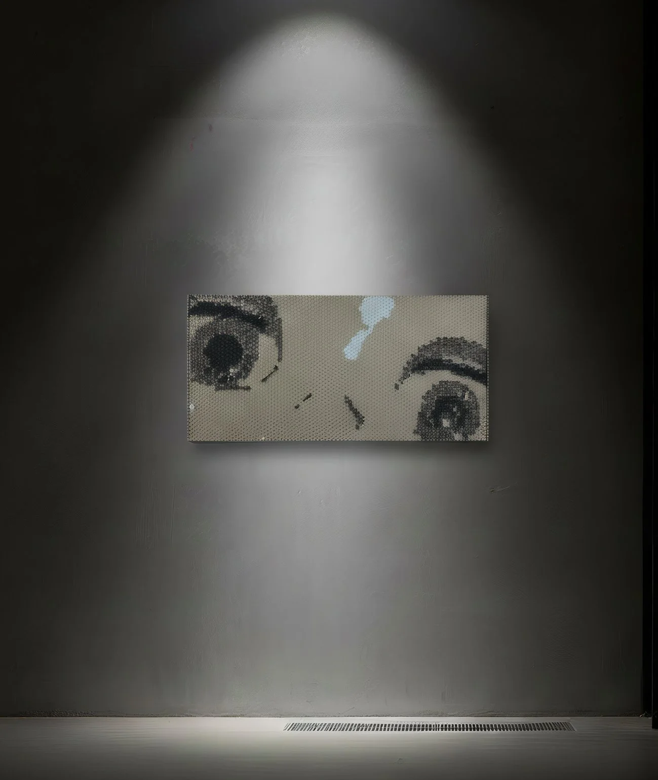 Artwork of a face with one eye winking, made with small mosaic tiles, displayed on a dark wall with spotlighting