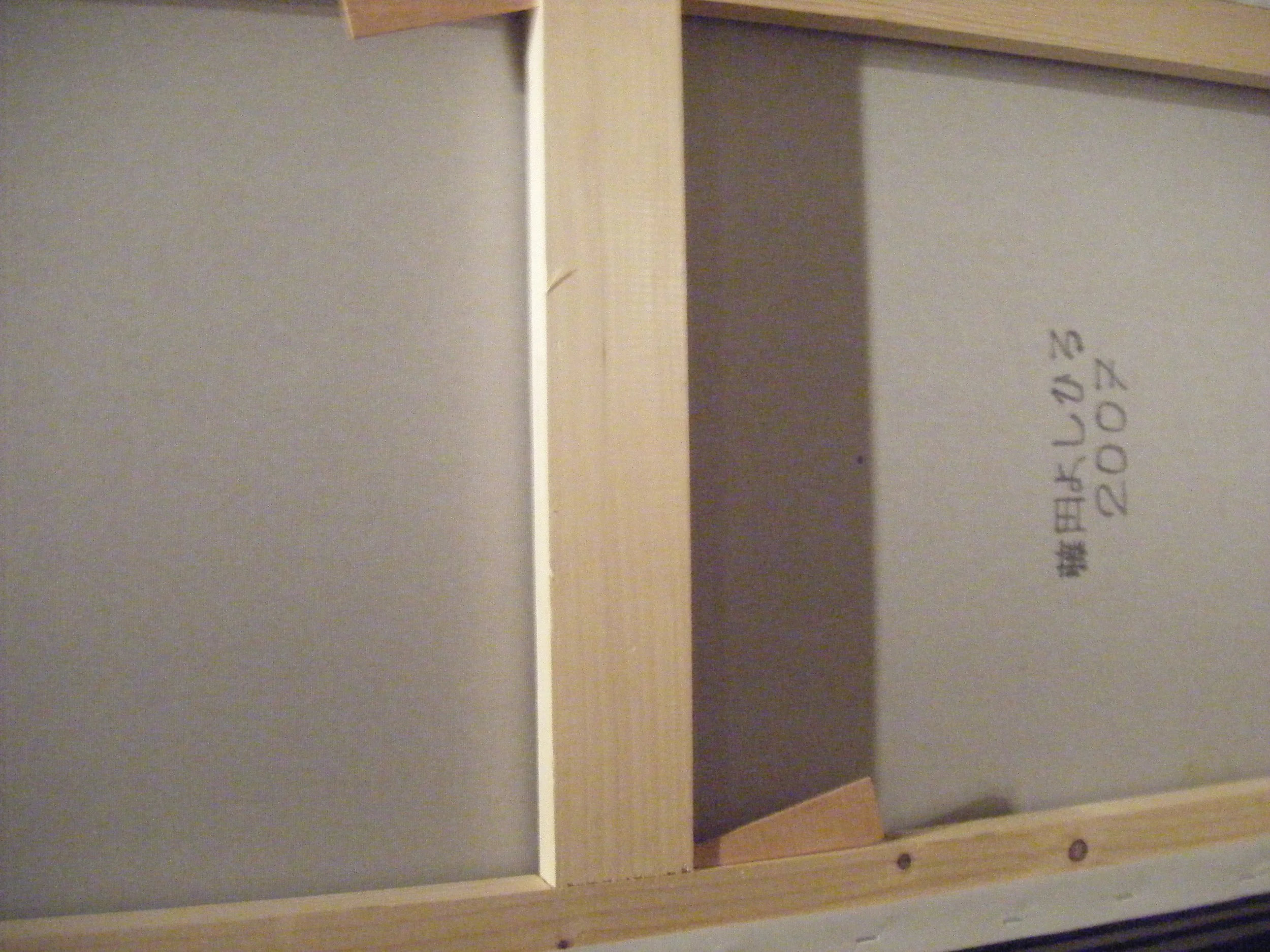 Close-up of a light gray cabinet or drawer with handwritten notes and date '2023'.