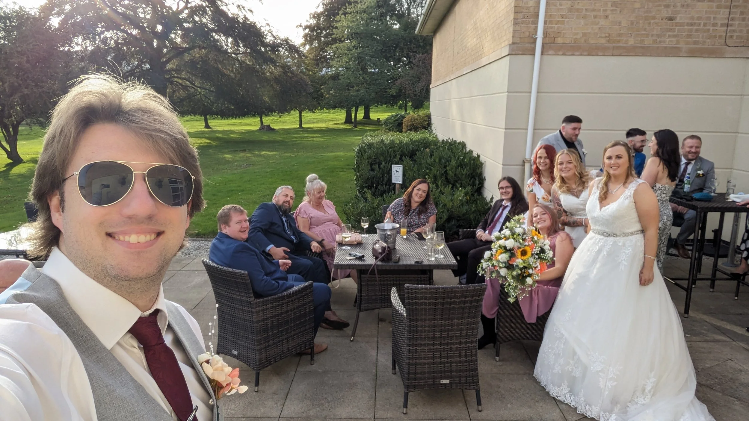 A wedding videographer from Everlight Studios taking a picture with the Bride and her guests at a Wedding during a Wedding Film shoot
