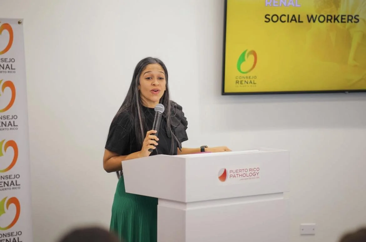 Woman speaking at a podium with a microphone during a presentation at Puerto Rico Pathology event.