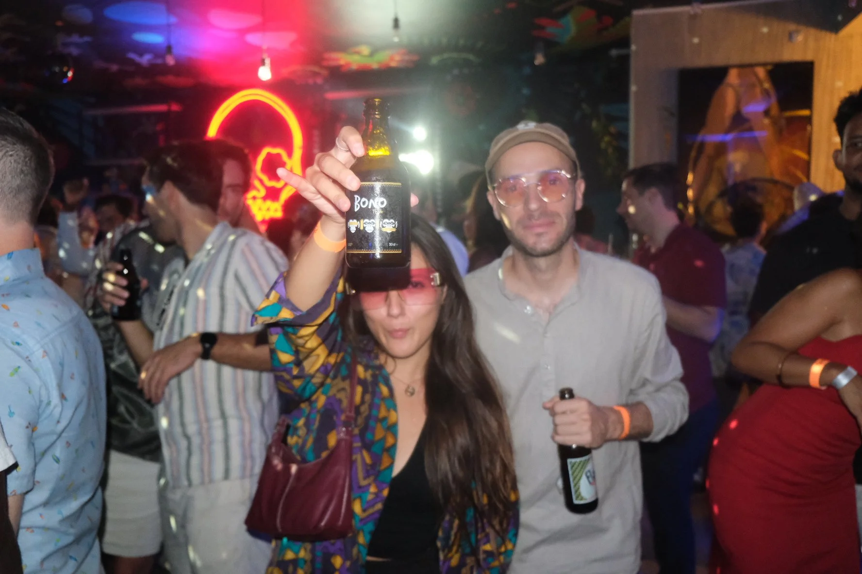Lady holding a beer bottle at a party