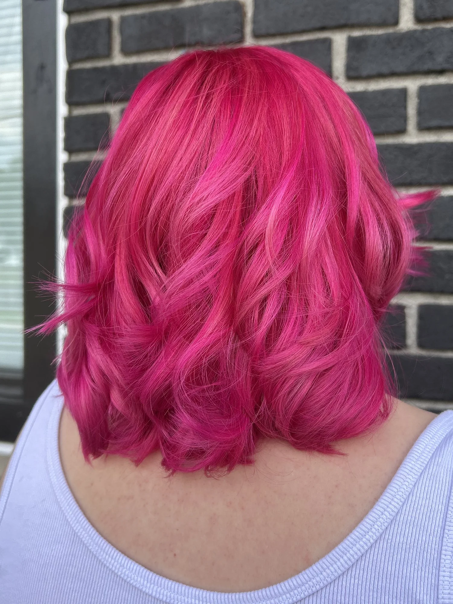 Magenta color on short hairstyle.