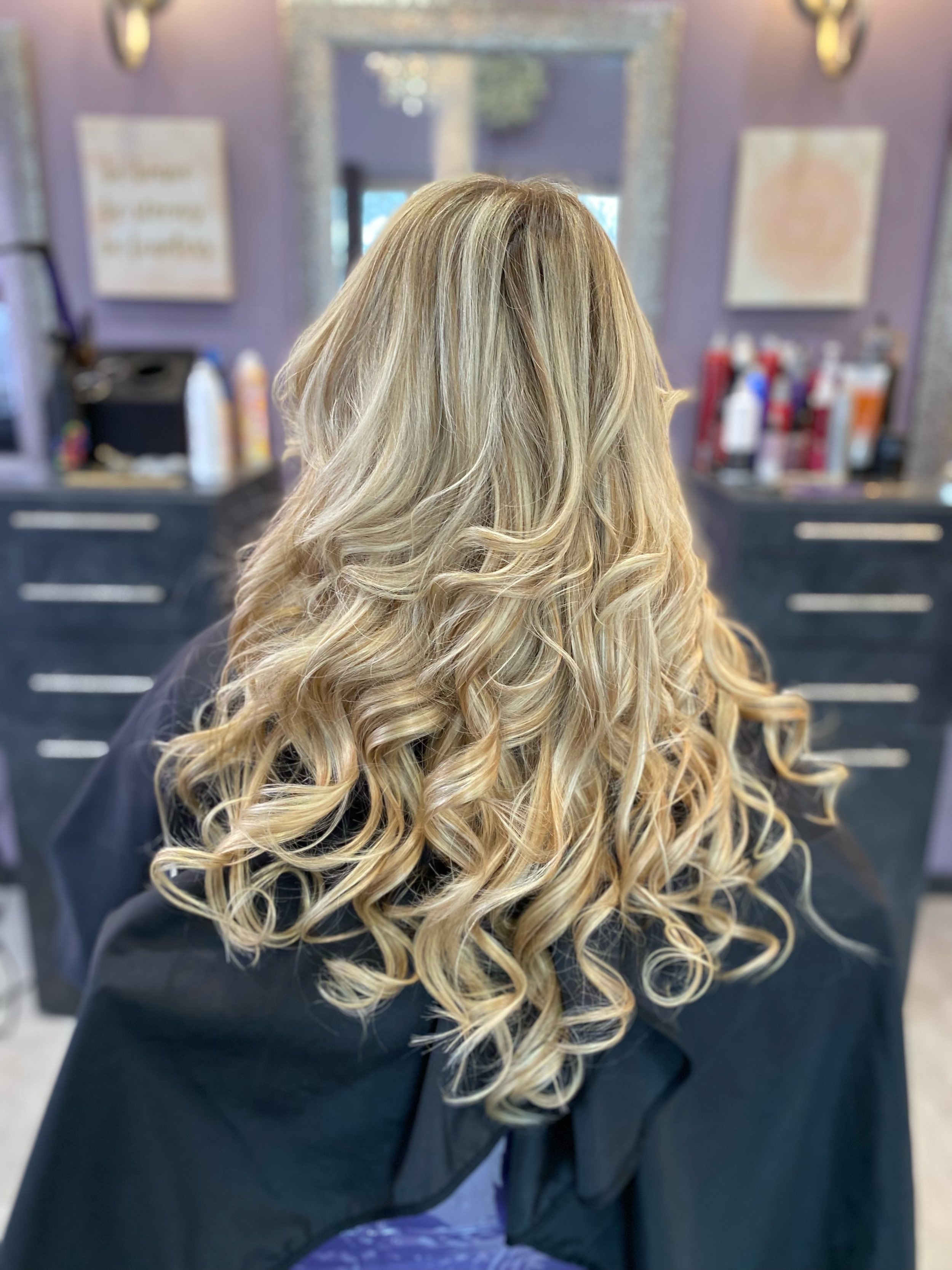 Long hair with blond highlights and curls.