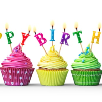 Three cupcakes with pink, yellow, and green frosting, each topped with colorful birthday candle letters spelling 'Happy Birthday' and lit
