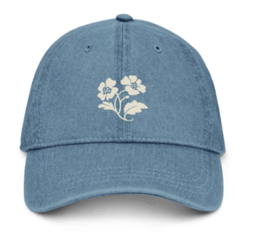 Blue baseball cap with white floral design on front