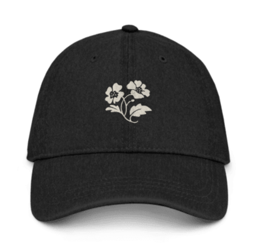 Black baseball cap with white floral embroidery on the front