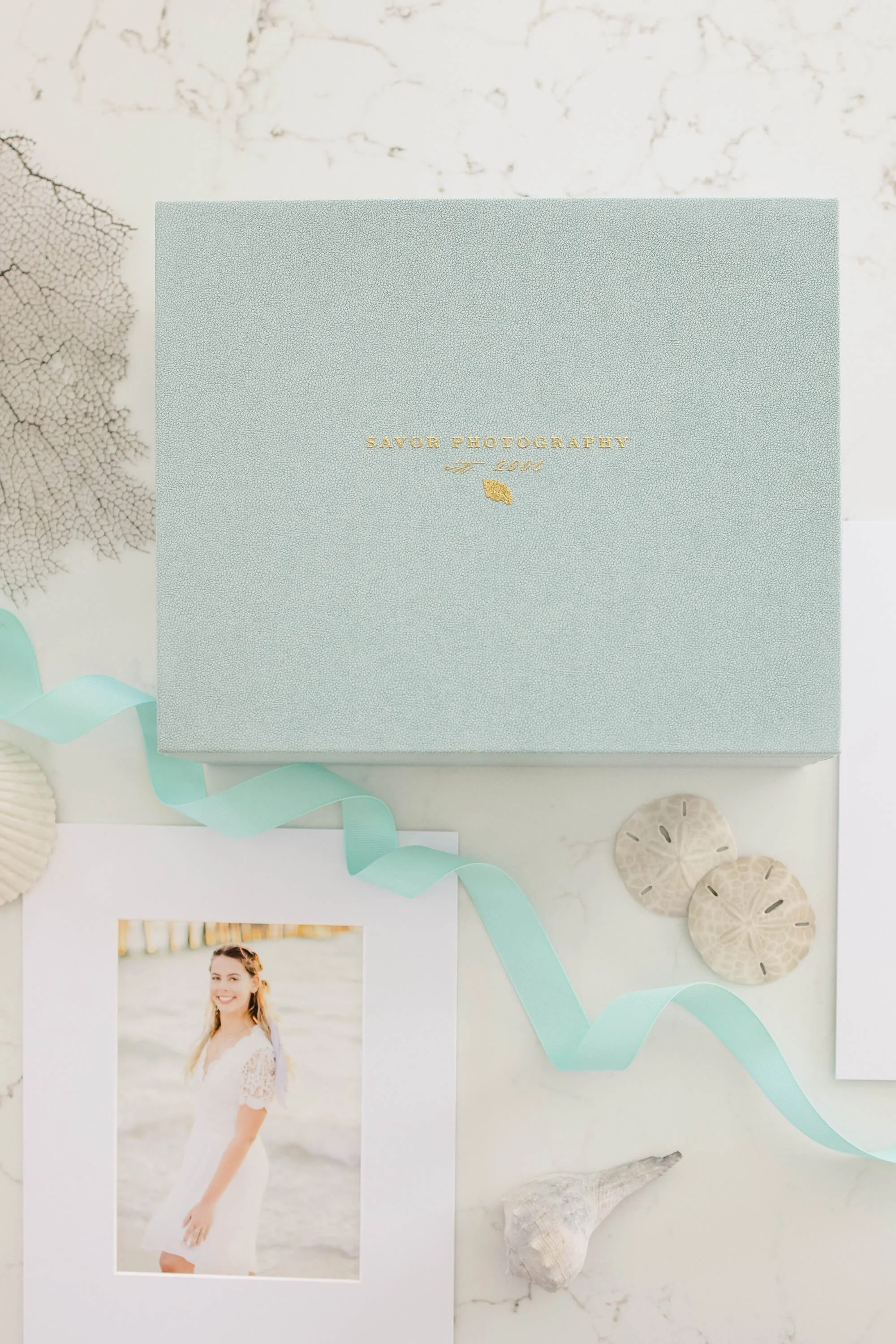 Archival print box with matted family portrait prints from a Naples family photography session.