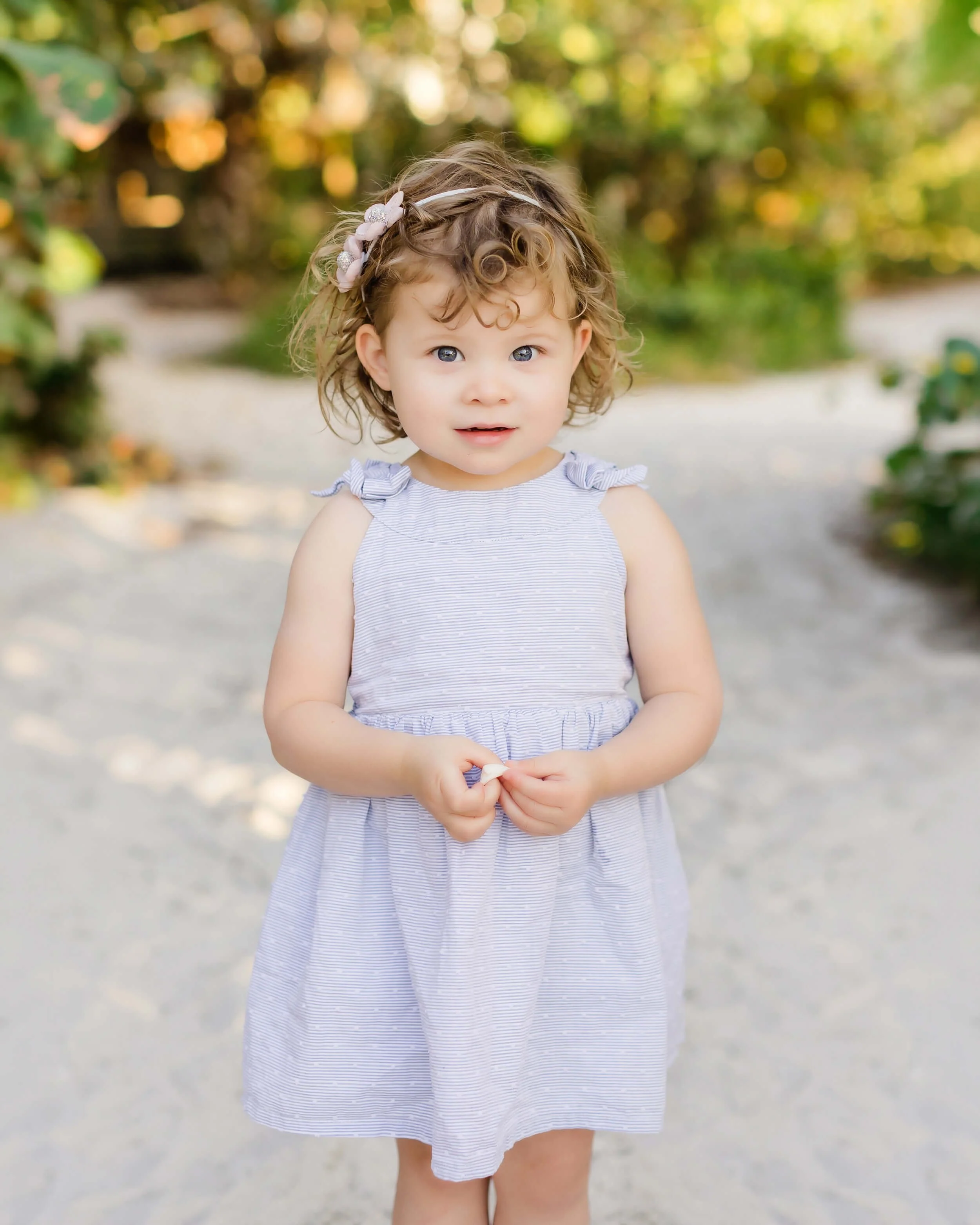Toddler girl portrait in a garden setting in Naples Florida photographed by Savor Photography