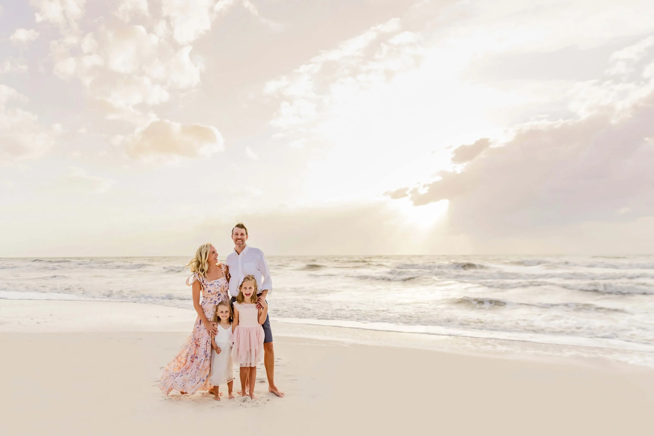 Family beach portrait at sunset on the Gulf coast by a photographer in Naples FL