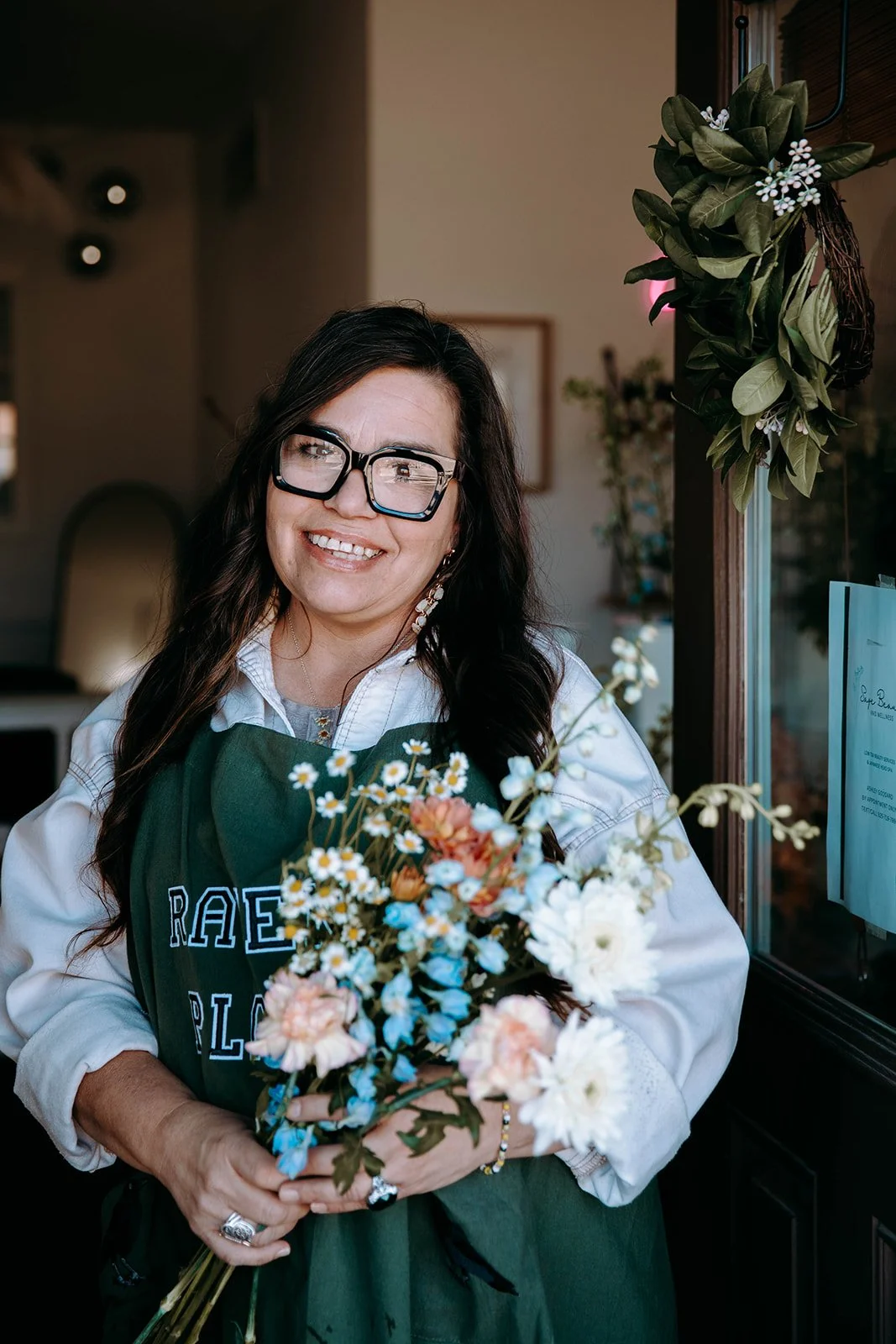 Raven's Place Owner with Floral Arrangement.jpg