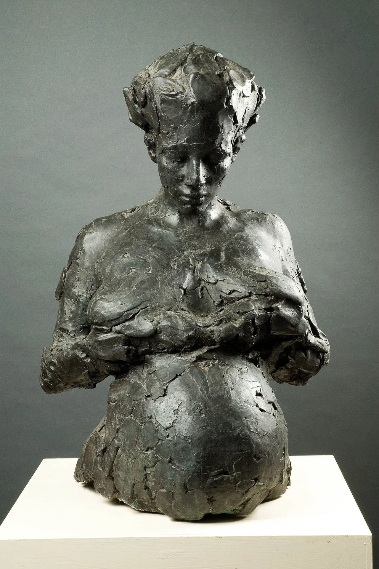 A bronzen sculpture by sculptor Brian Taylor of his wife Michele Franklin, pregnant with her arms crossed over her chest.
