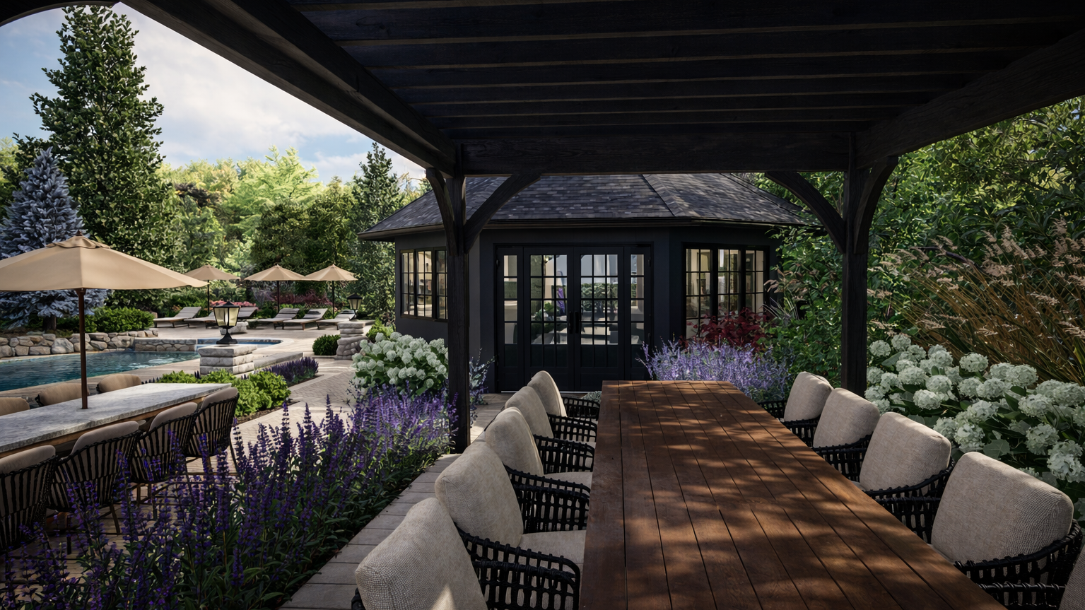 Outdoor patio with a large dining table and cushioned chairs, surrounded by lush greenery and white flowers, with a gazebo in the background.
