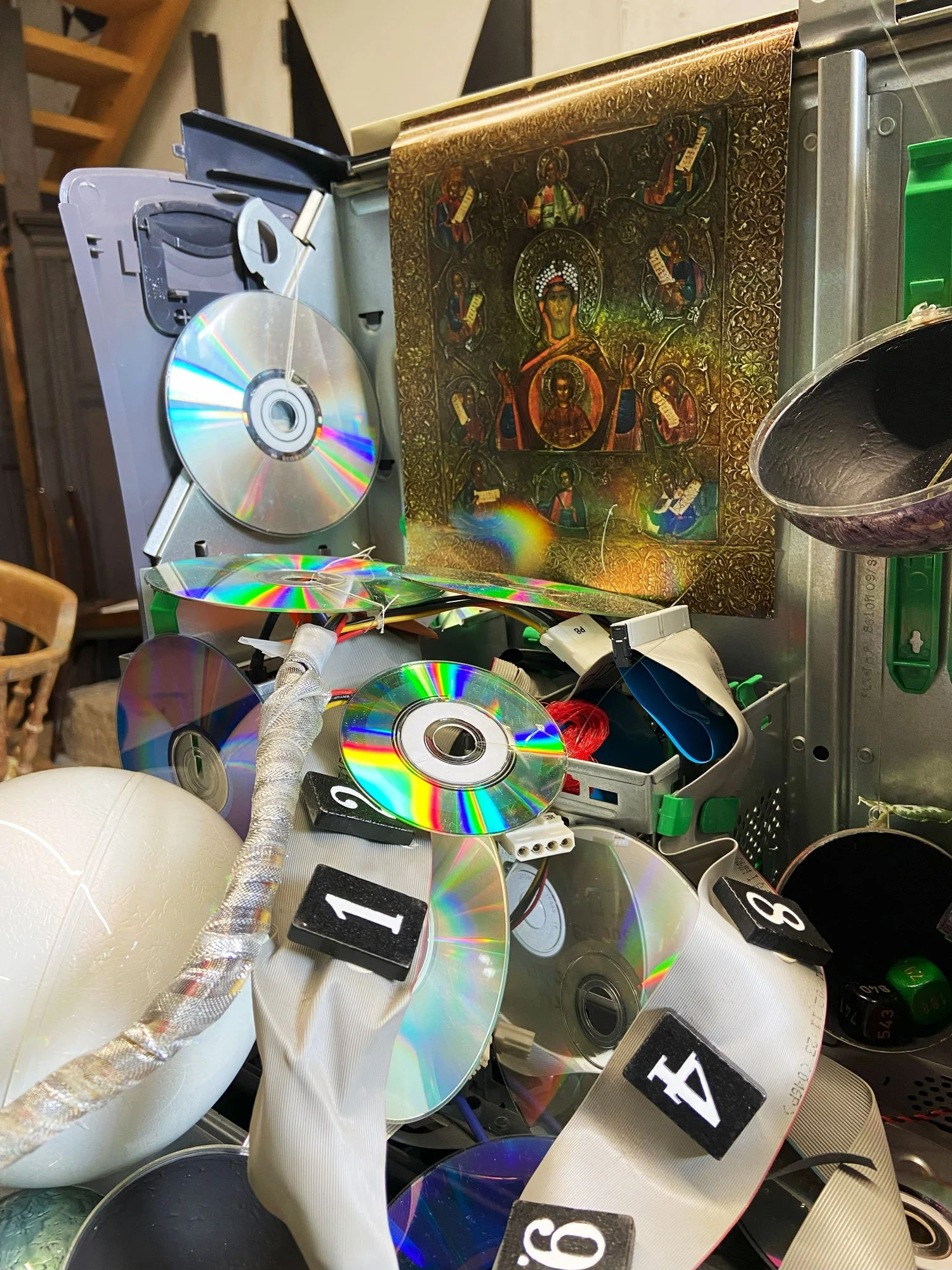 Mixed-media sculpture made from parts of an old computer, CDs, and other repurposed materials