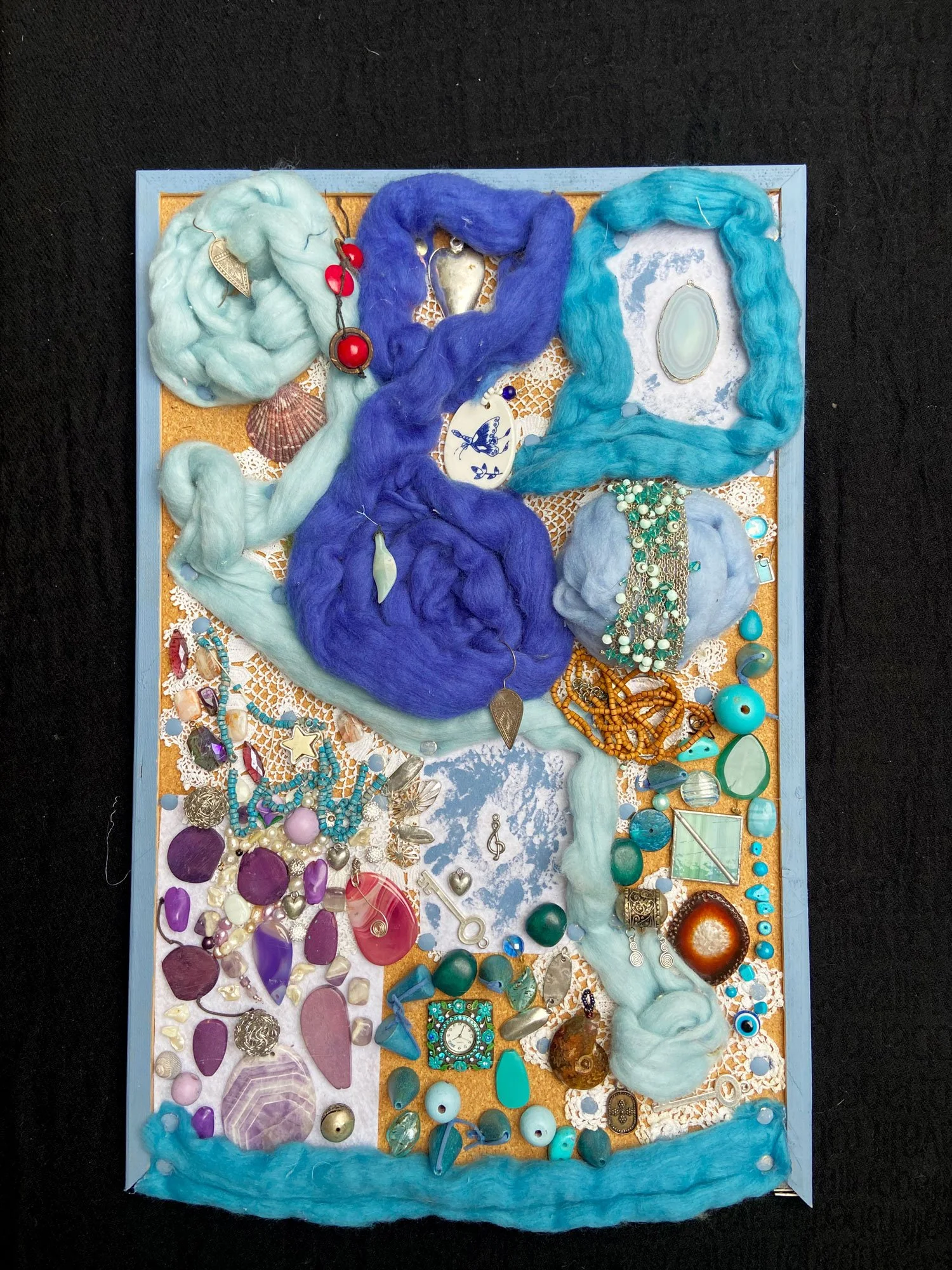 Abstract artwork made from recycled jewellery, beads, and soft fibres, created through intuitive crafting in a Gestaltete Interaktion workshop
