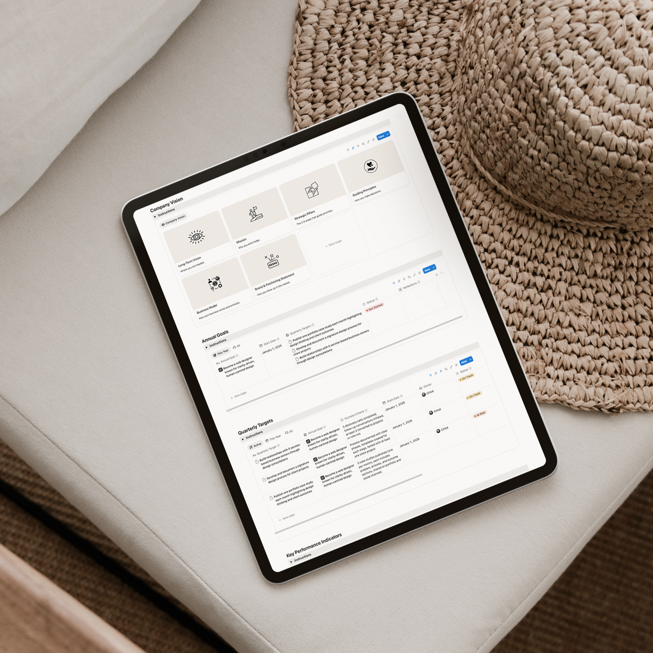 Tablet displaying a Notion business strategy dashboard with company vision, annual goals and quarterly targets.