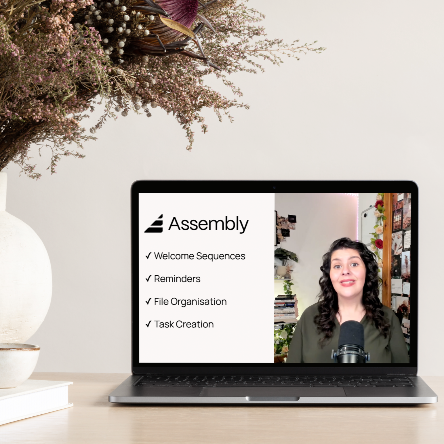 Laptop displaying an Assembly client portal workflow demonstration by Chloë Forbes-Kindlen showing welcome sequences, reminders, file organisation and task creation.