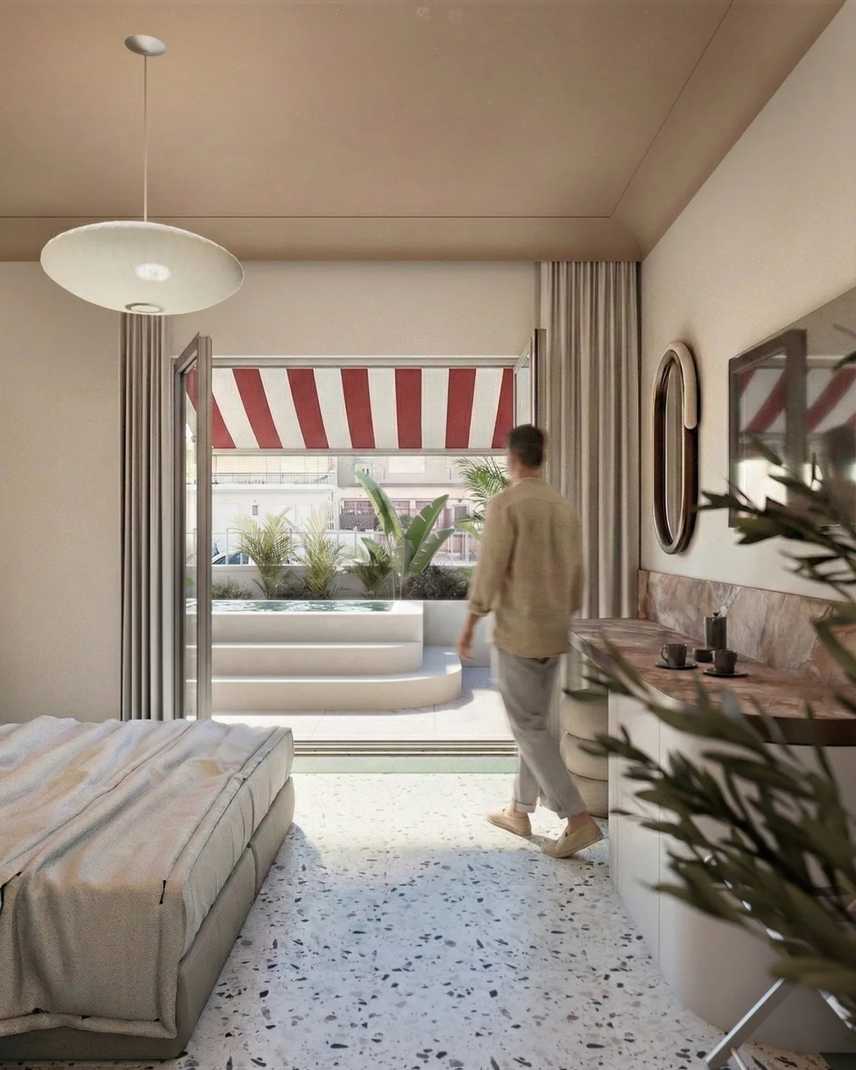 A person walking into a bright bedroom from a balcony with a red and white striped awning. The room has a bed with a beige and white striped blanket, terrazzo flooring, and a sideboard with cups and a coffee maker. Green plants are outside on the balcony.