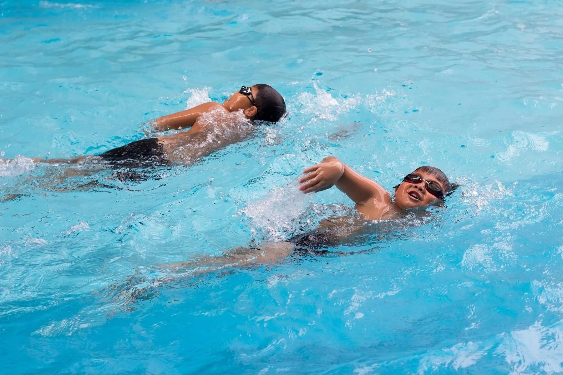 Two kids during a swimming exercise.