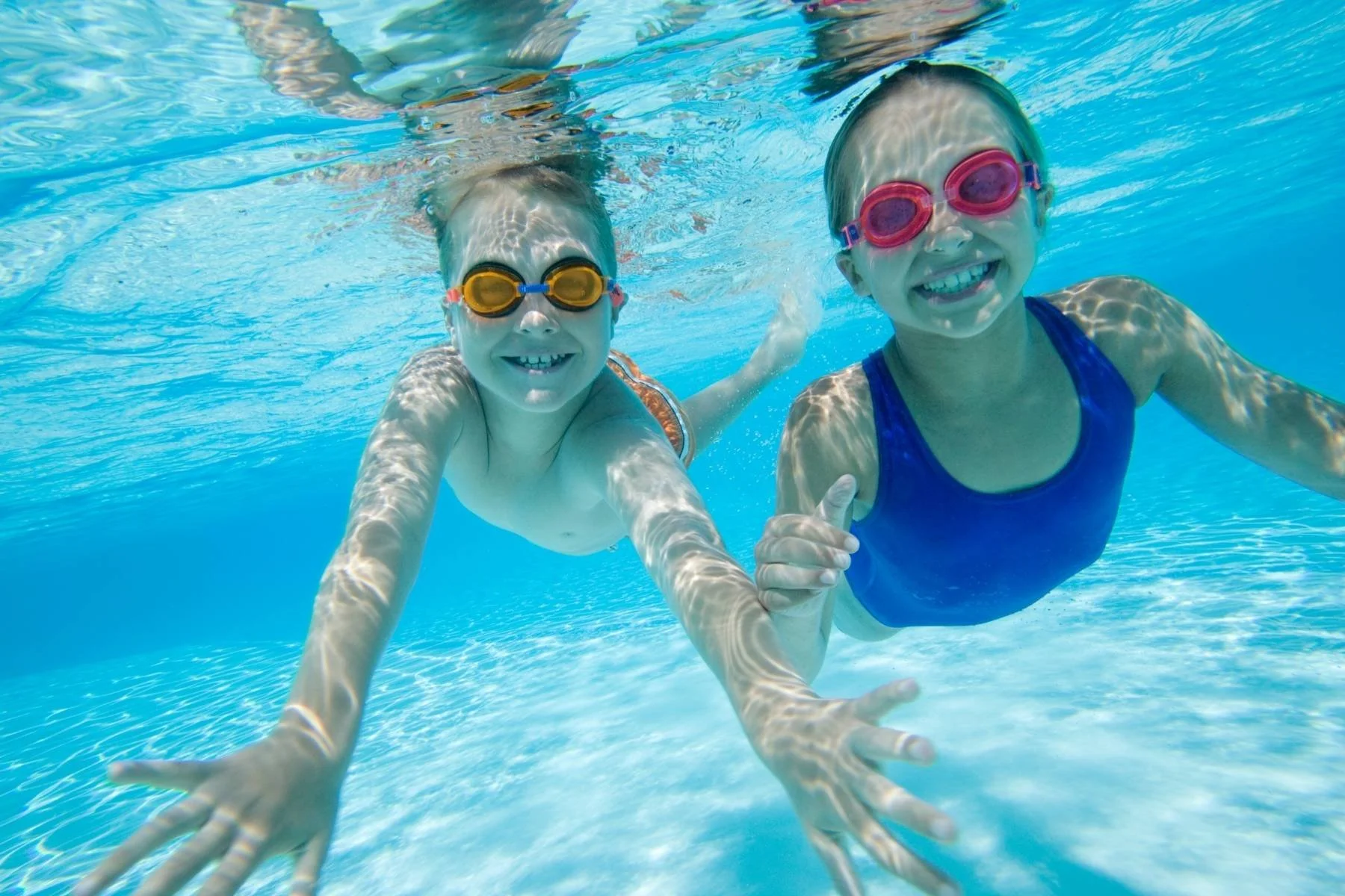 Two swimming students during group swimming lessons.