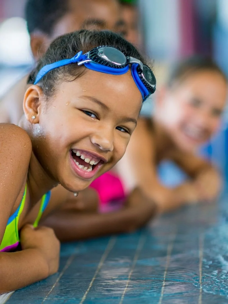 Smillng young swimming student.