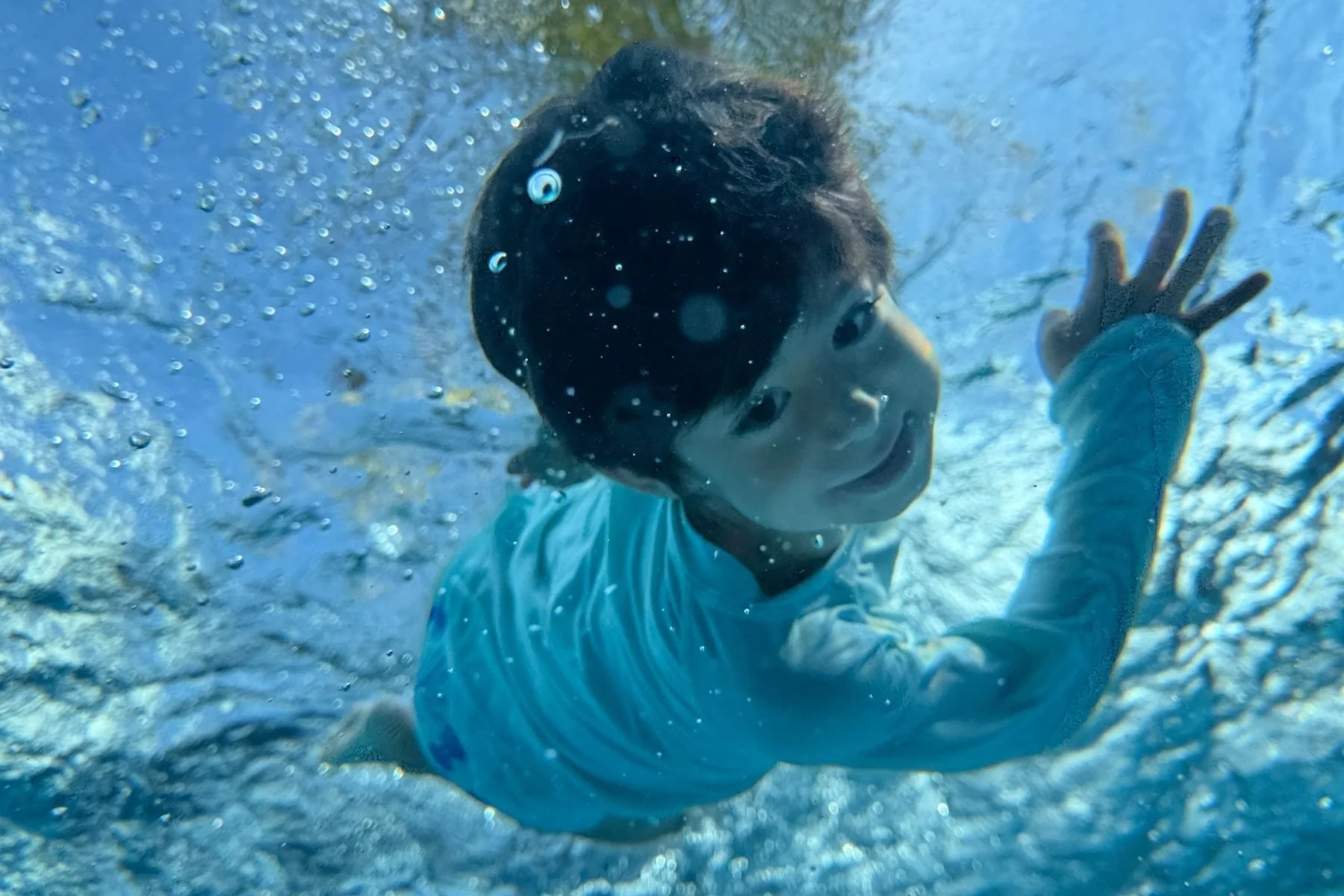 Young swimming student during private swimming lessons.