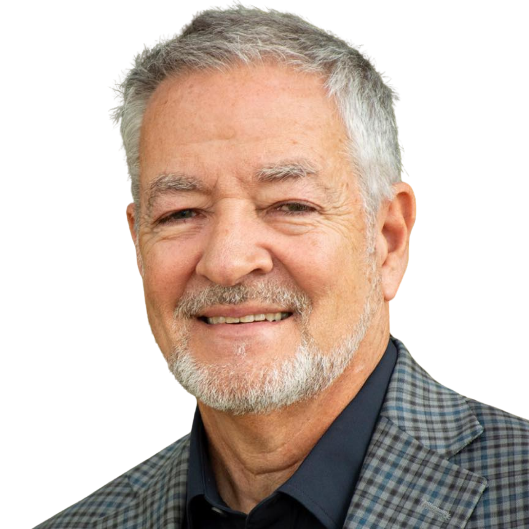 Close-up of a smiling elderly man with gray hair, wearing a checkered blazer and a navy shirt, against a dark background.
