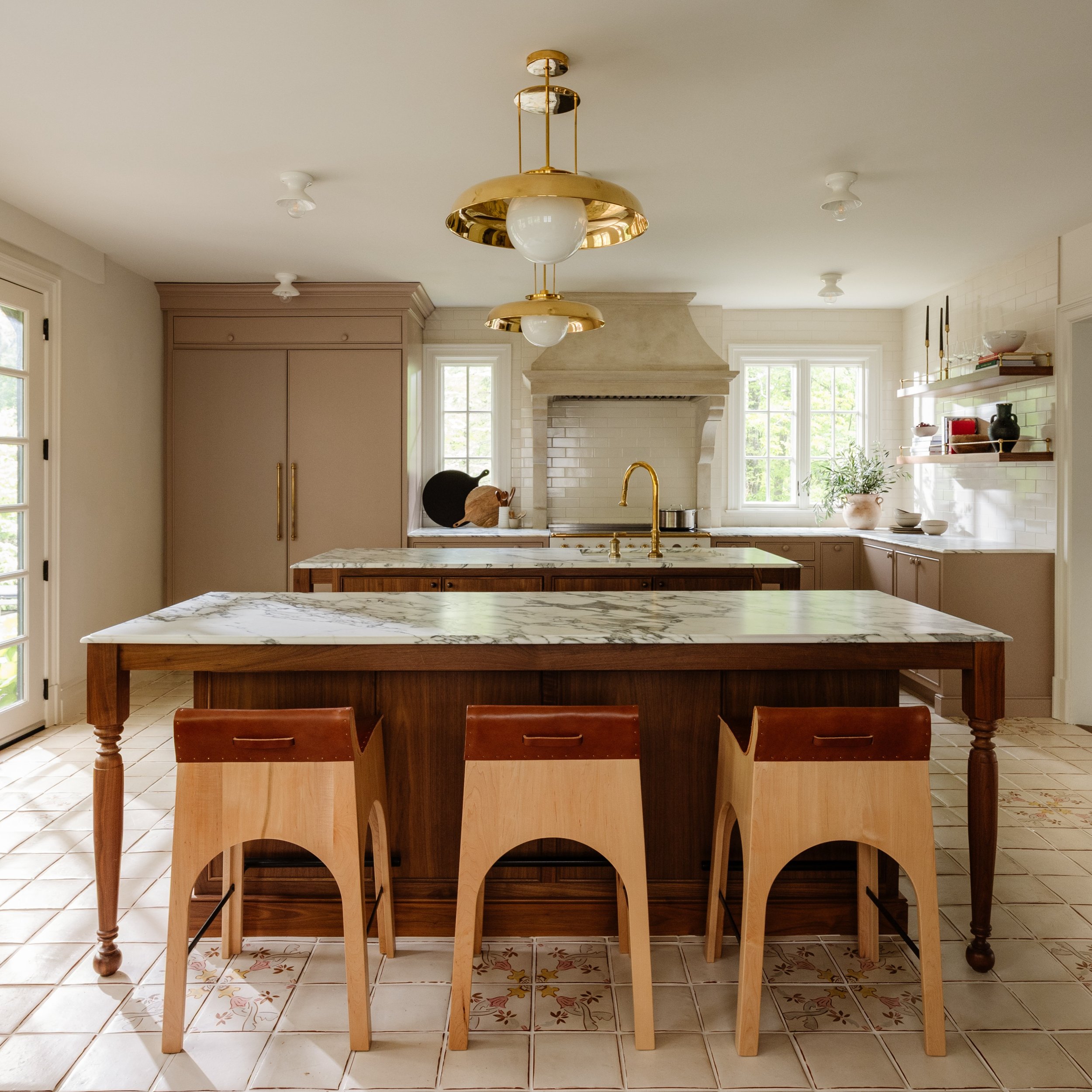 A moment for the kitchen 🍽 The original layout was closed off by a bulky peninsula island, limiting flow and connection. We opened the space into one expansive room with multiple zones. Two islands create ample prep space and extra seating for famil