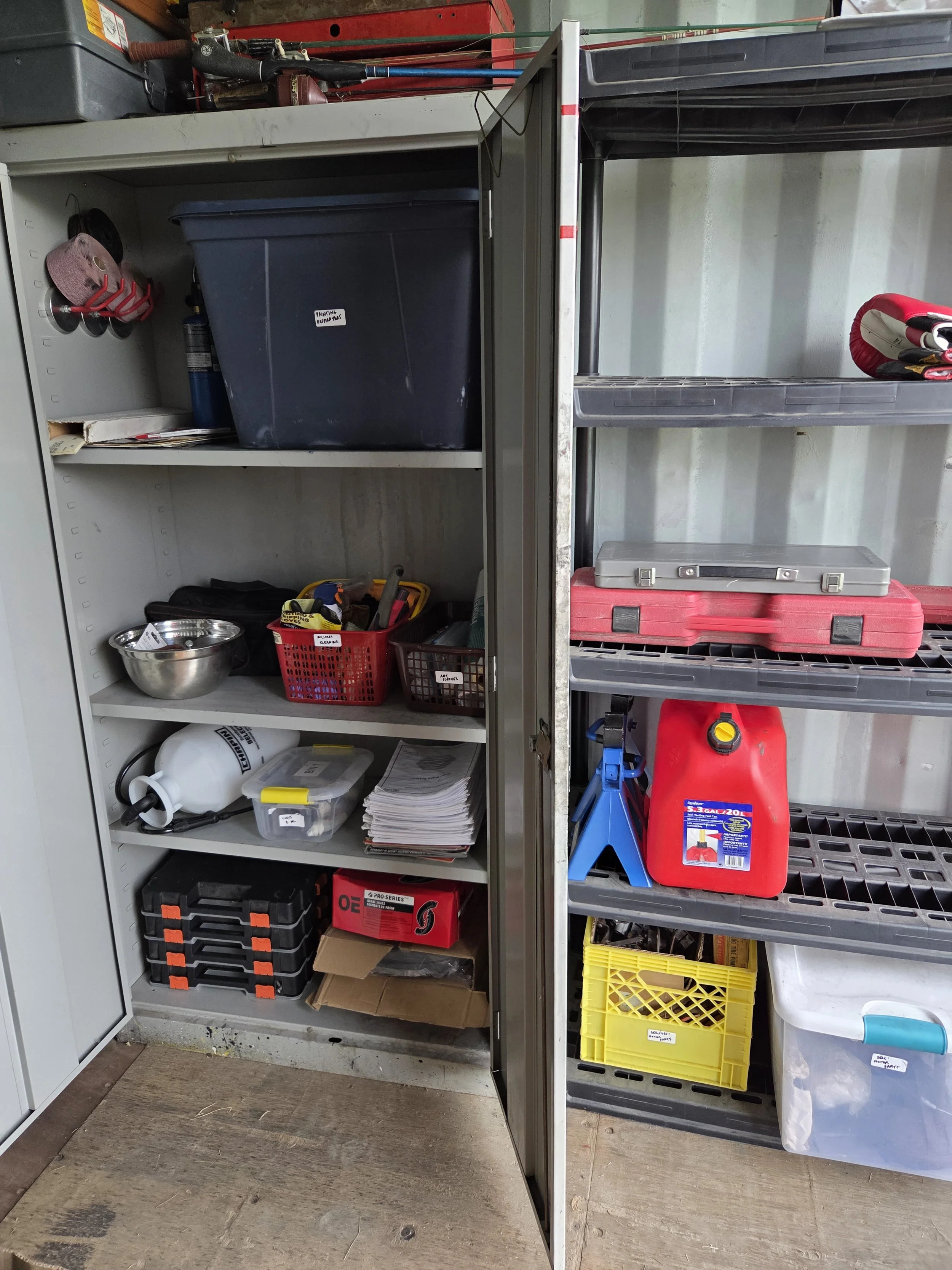 A seacan garage unit which shows clearly labeled working zones, shelf space which is now accessible and accepting more storage, and all items are stored based on their usage level/priority of needs.