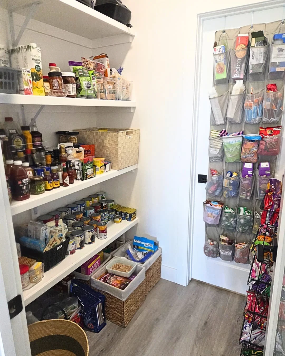 Kitchen pantry with an abundance of snacks and food items, food categories stored within individual bins and sections