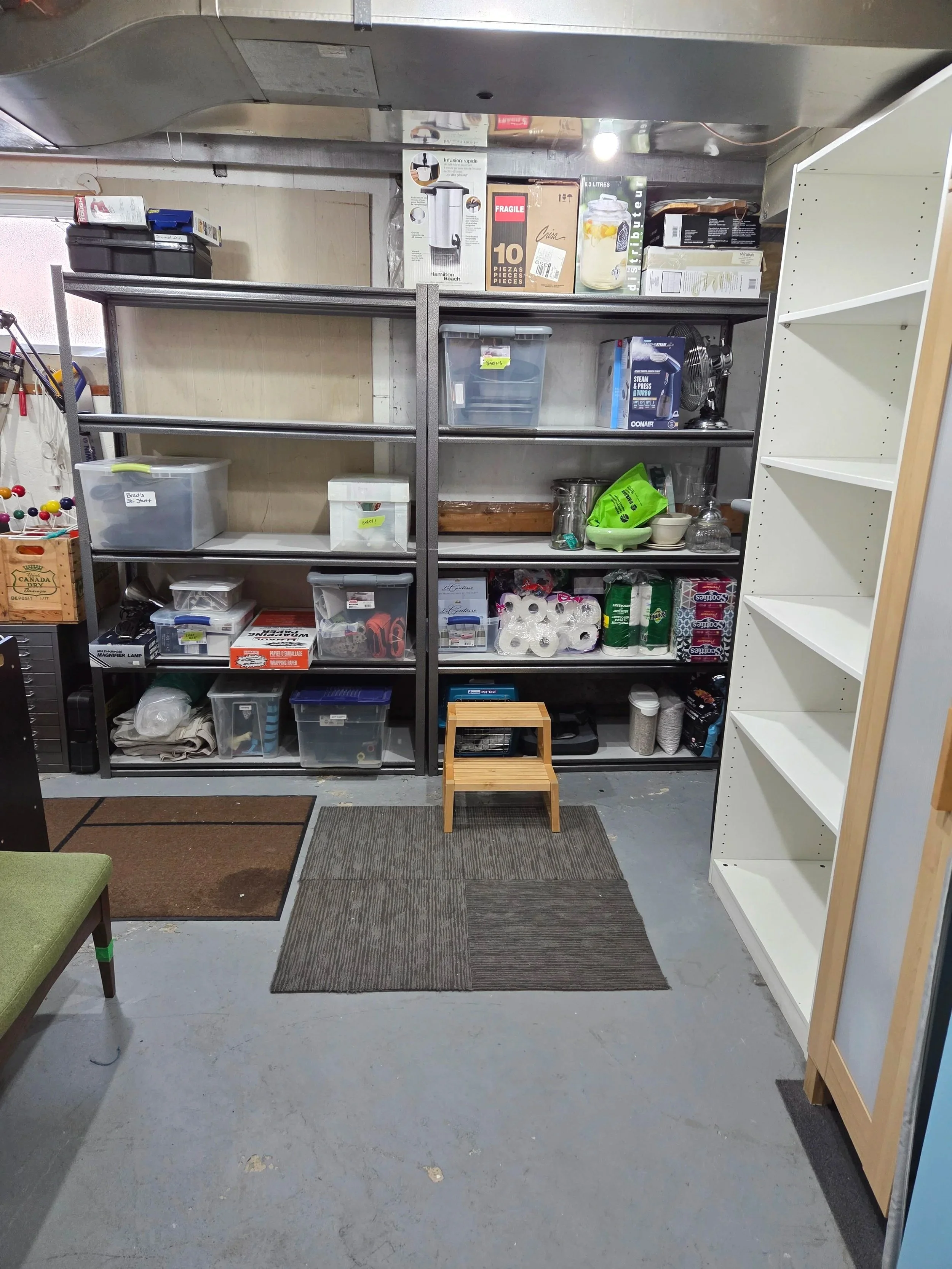 Organized and downsized furnace storage room with ample empty shelving space