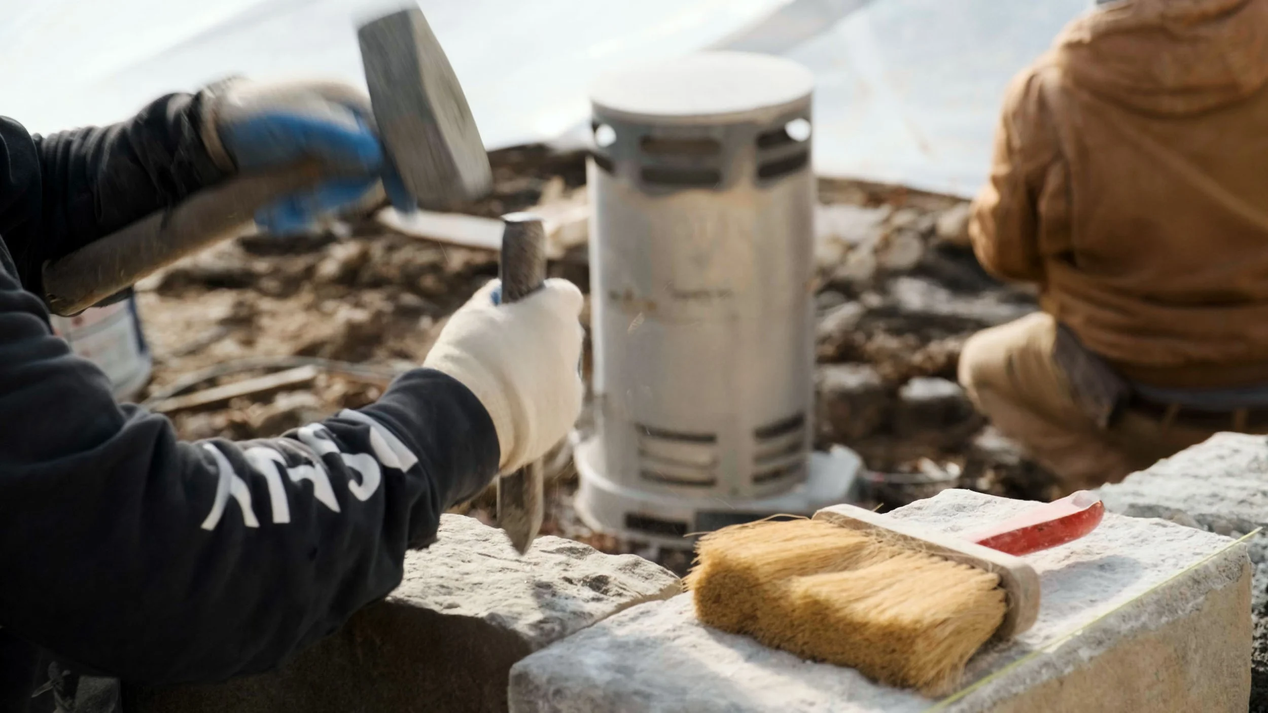Chiseling stone for a Japanese Castle-style rock wall in Pound Ridge, NY