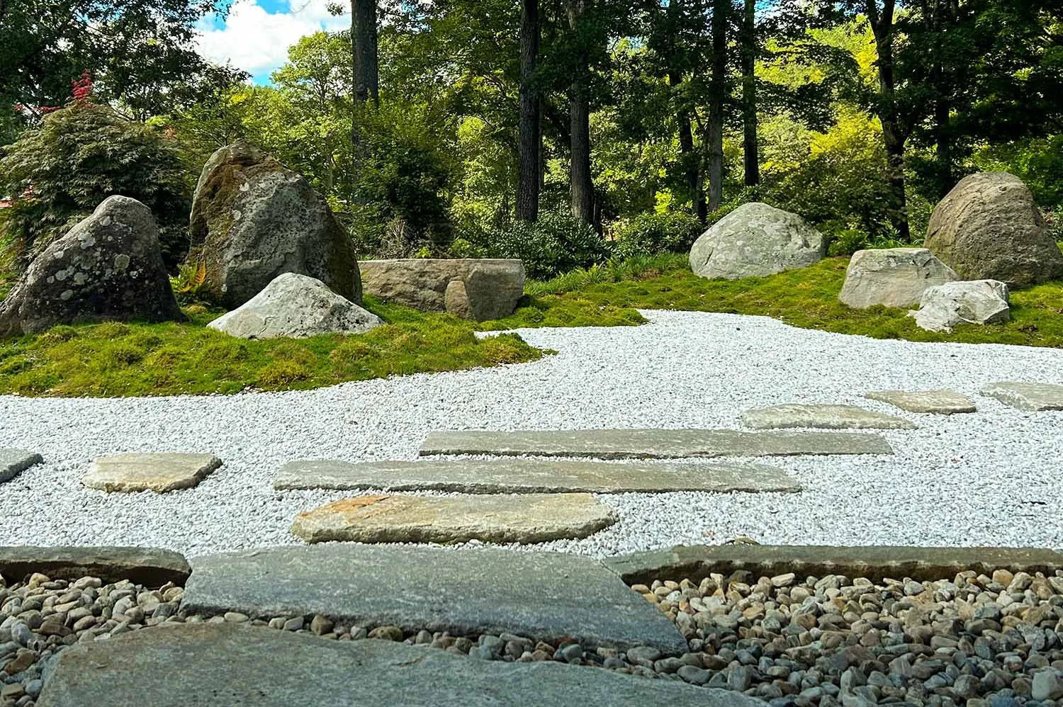 Japanese moss garden with Stone groupings with gravel and stone path