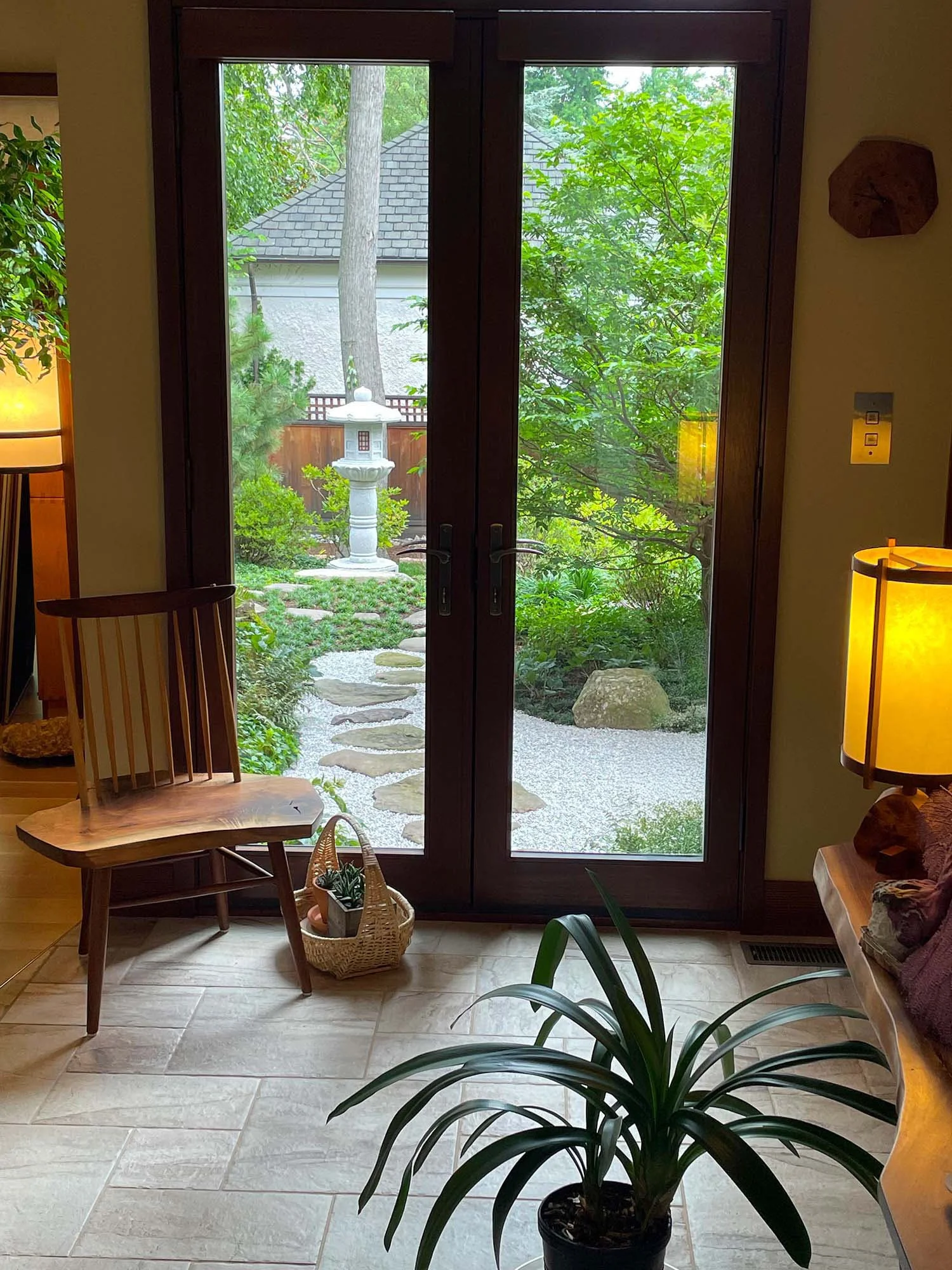 Japanese courtyard garden with stone lantern as viewed from inside a house