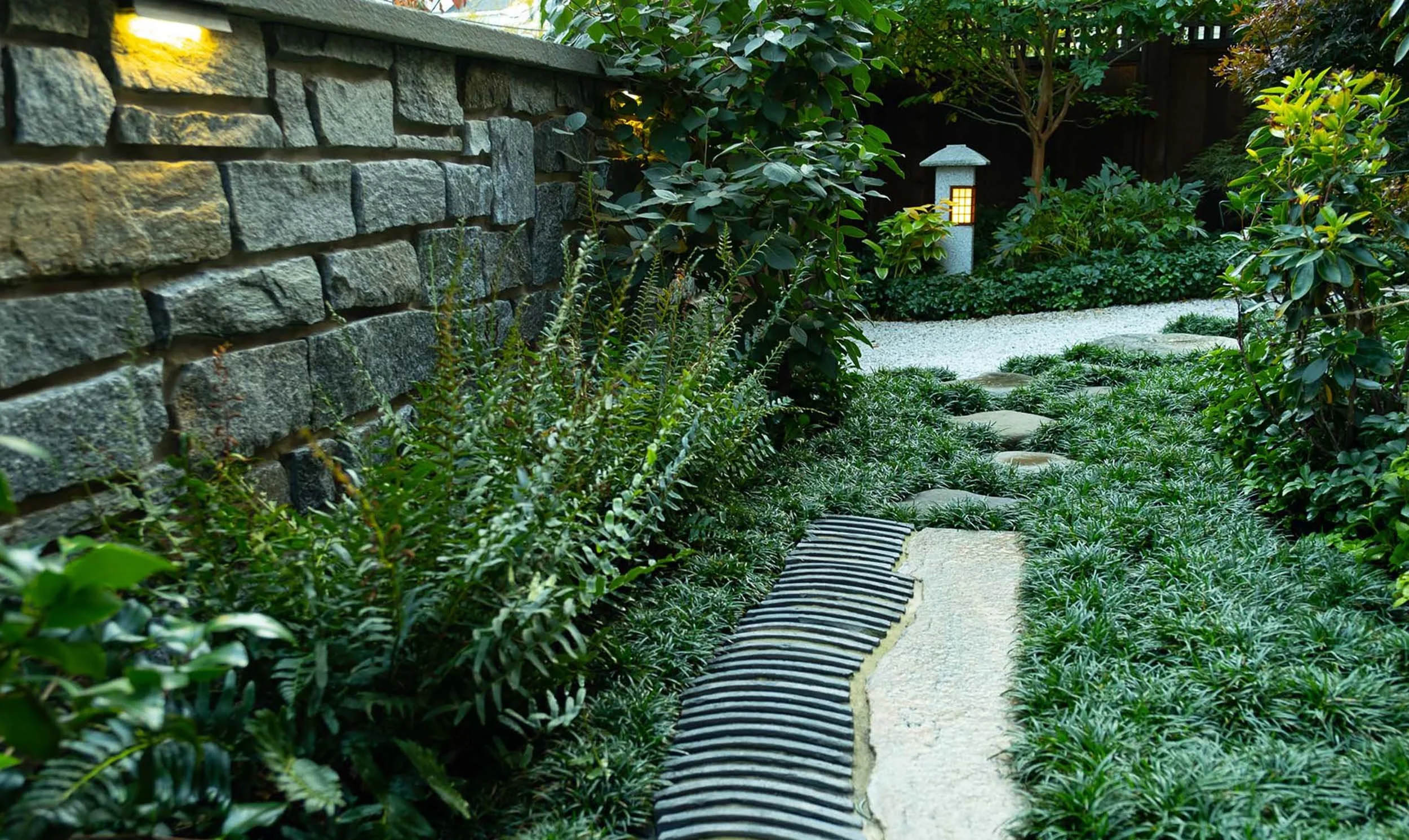 Urban alley garden with unique Japanese walkway using roof tiles and granite piece