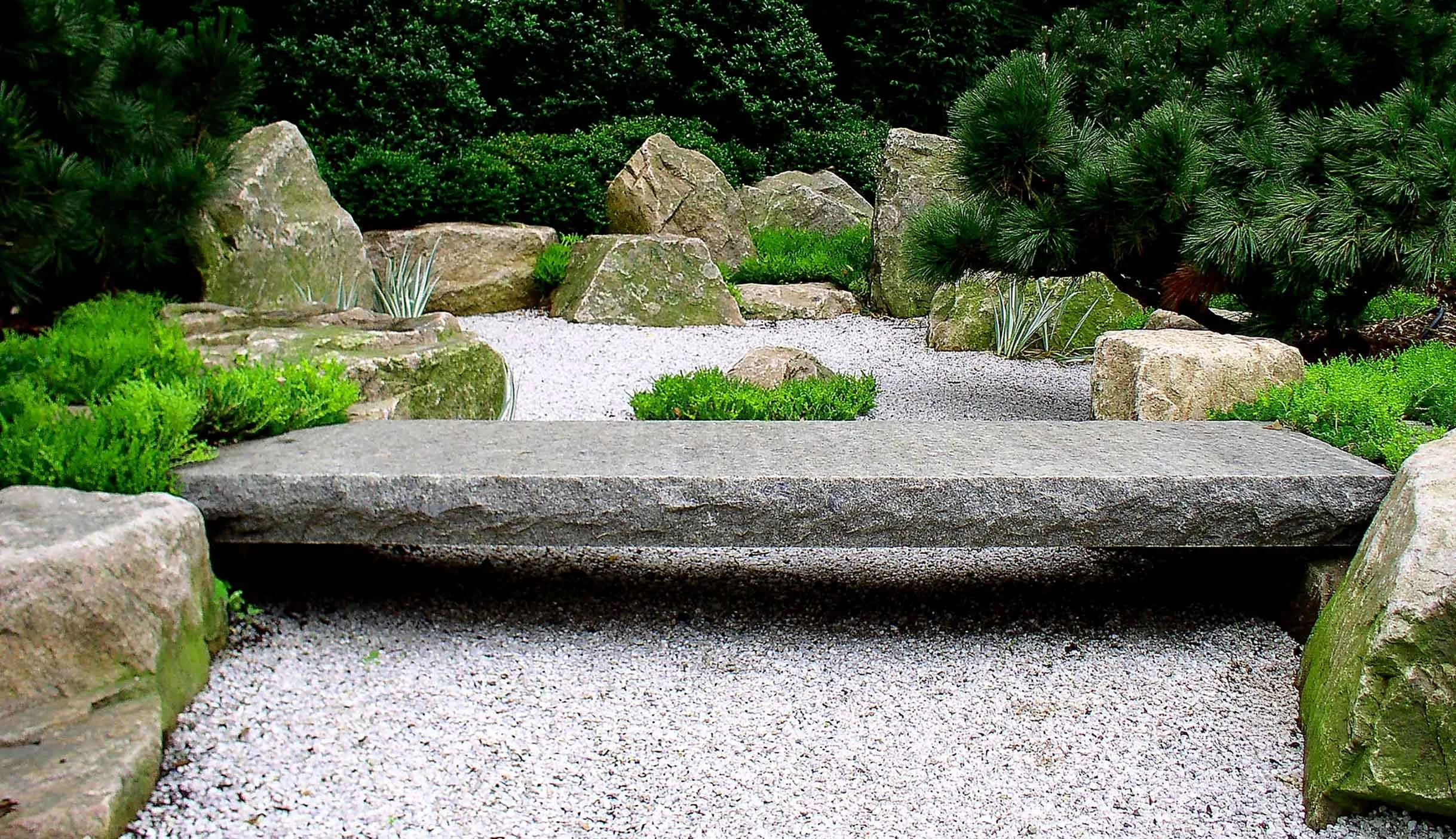 Authentic Japanese stone arrangement with stone bridge in a dry landscape garden
