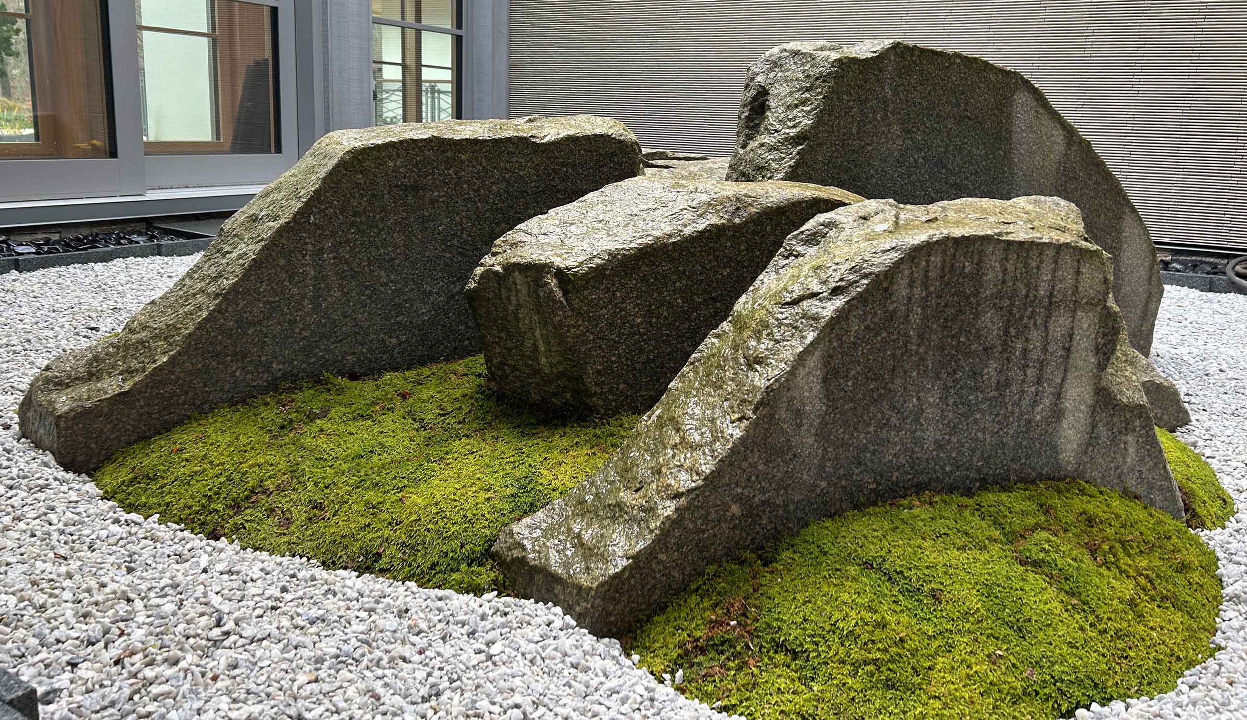 Sculptural Japanese courtyard atrium garden with moss and cut granite slices