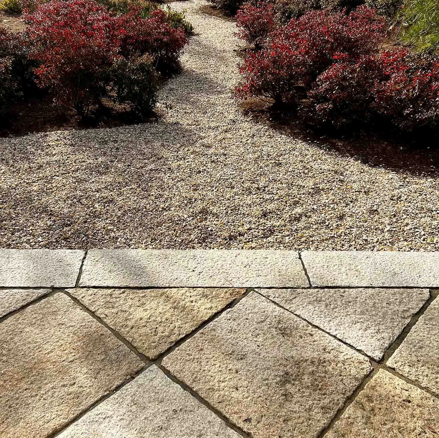 Japanese granite patio in a diamond pattern with azaleas and pea gravel path