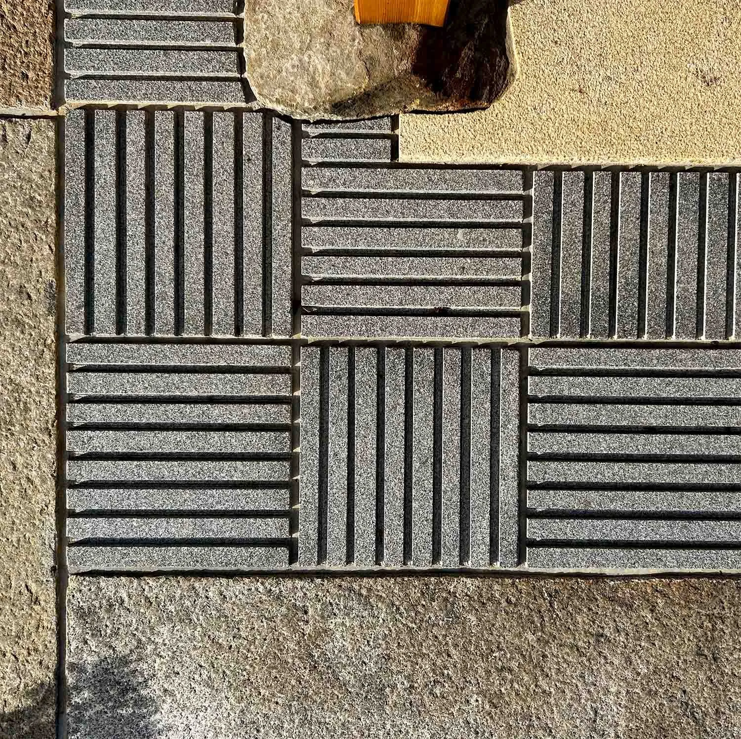 Patio detail under an authentic Japanese wooden gate with granite paving stones and unique design