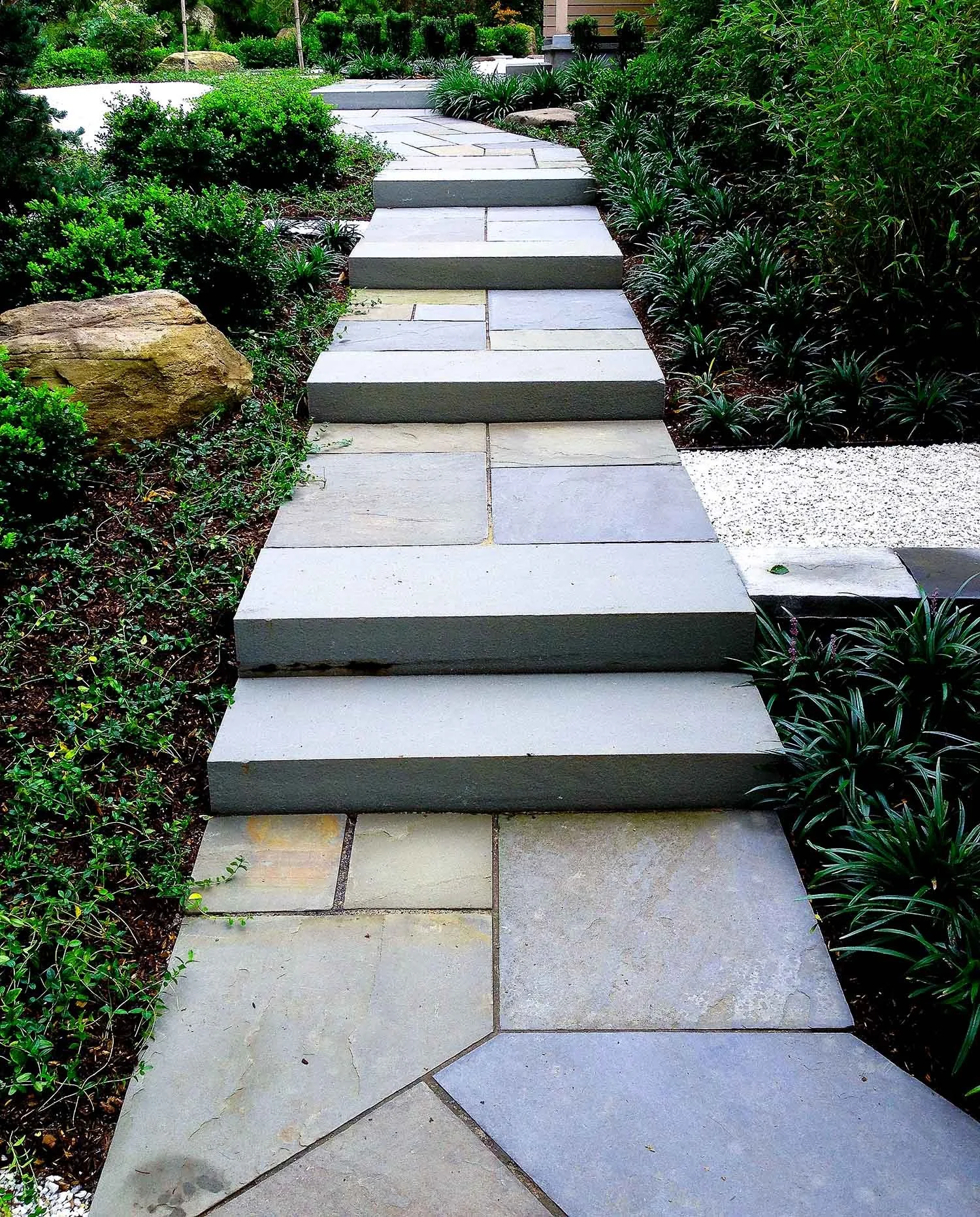 Bluestone path and steps in a front yard Japanese garden