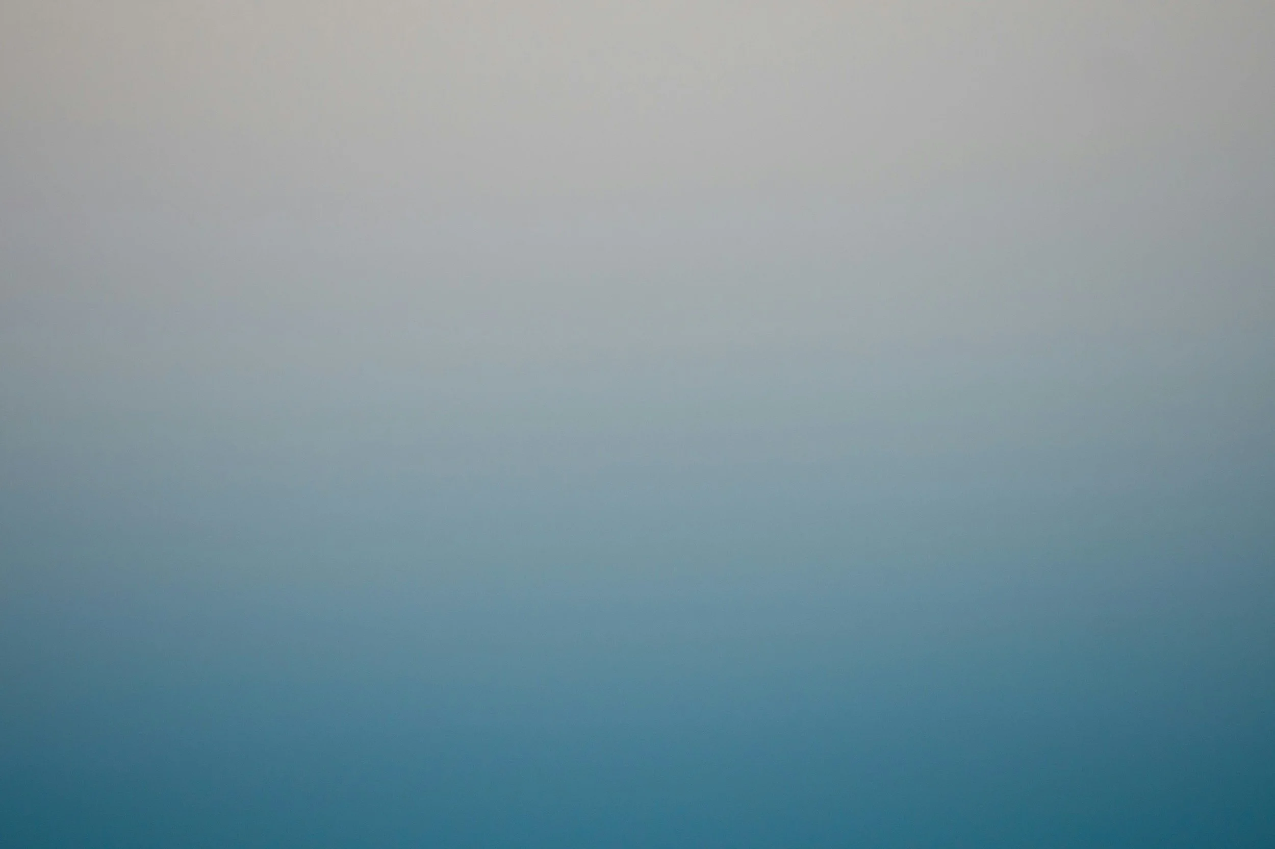 A gradient sky with shades of light gray to blue, no distinct objects or features.