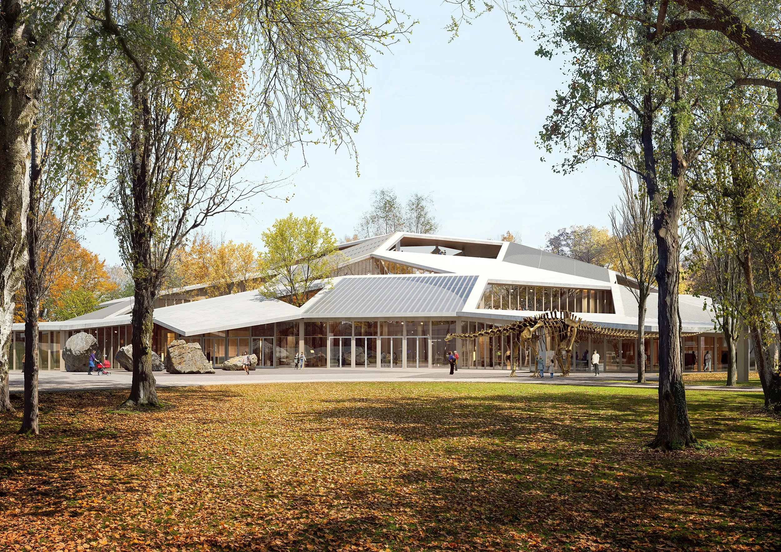 Modern building with large glass windows, surrounded by trees with autumn leaves, with people walking and a dinosaur skeleton exhibit outside.