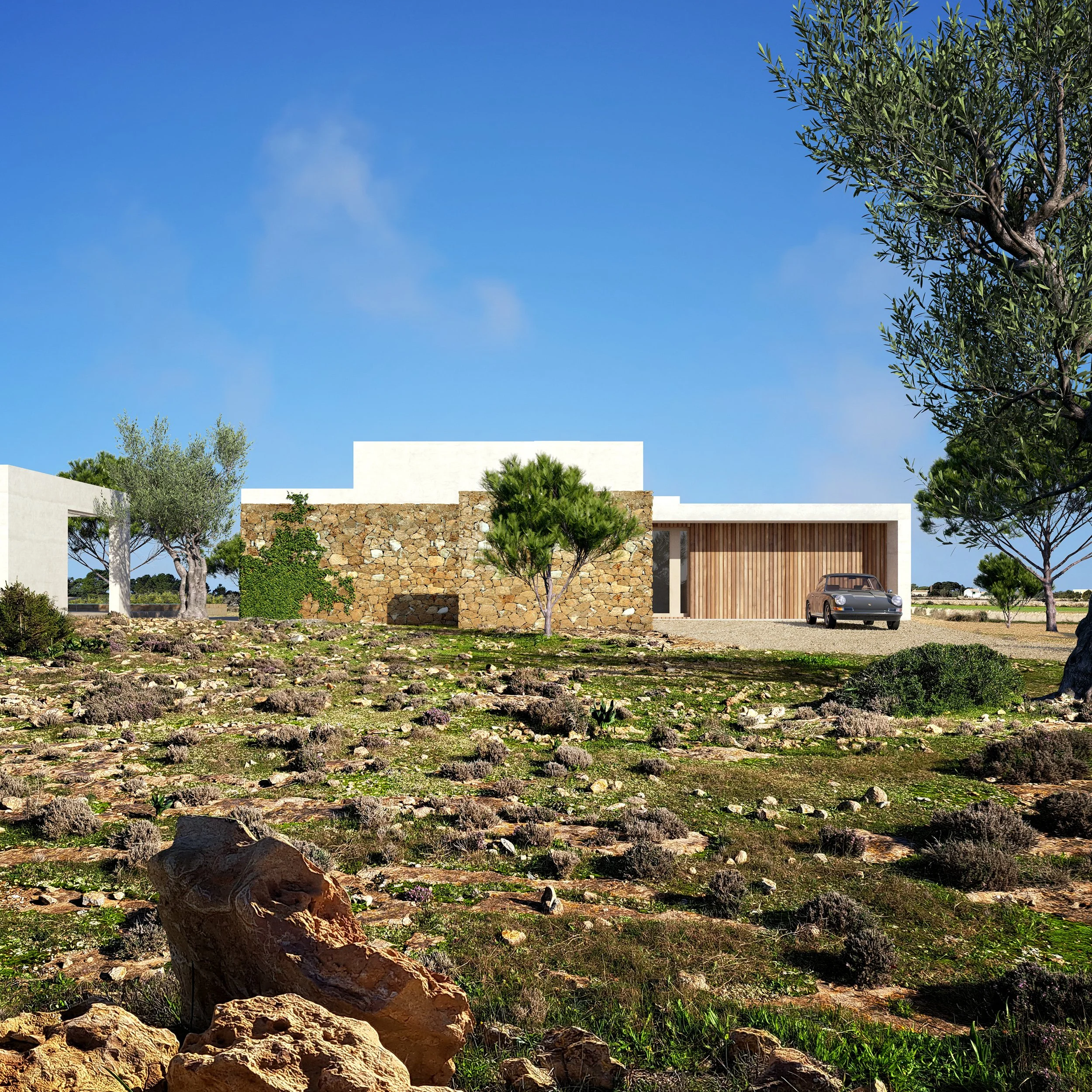 Modern house with white walls, a stone wall, and wooden garage door, surrounded by trees and rocky terrain under a blue sky.