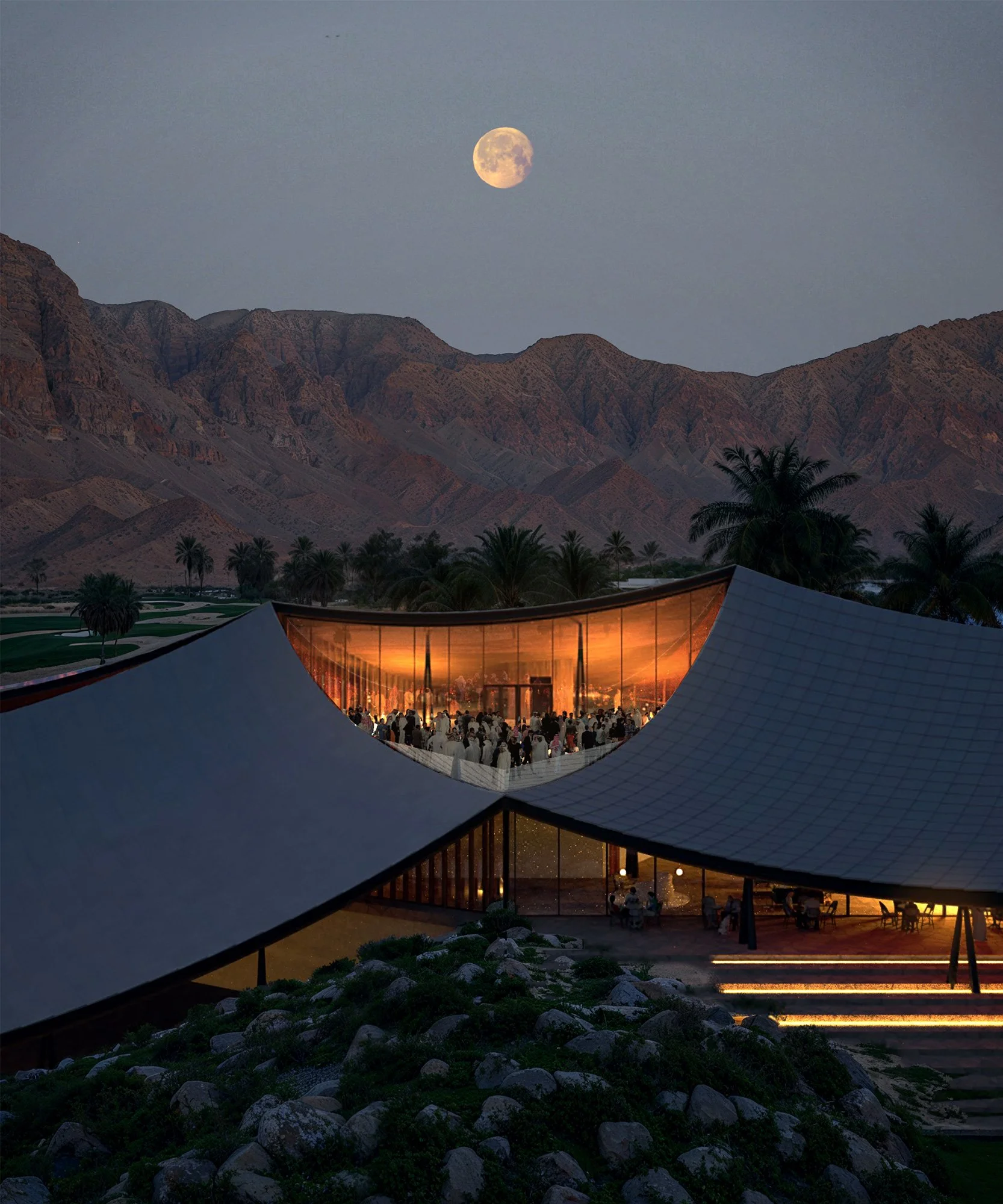 Nighttime scene of a modern building with a curved roof and glass walls, illuminated from within, set in a desert landscape with palm trees, mountains in the background, and a full moon overhead.
